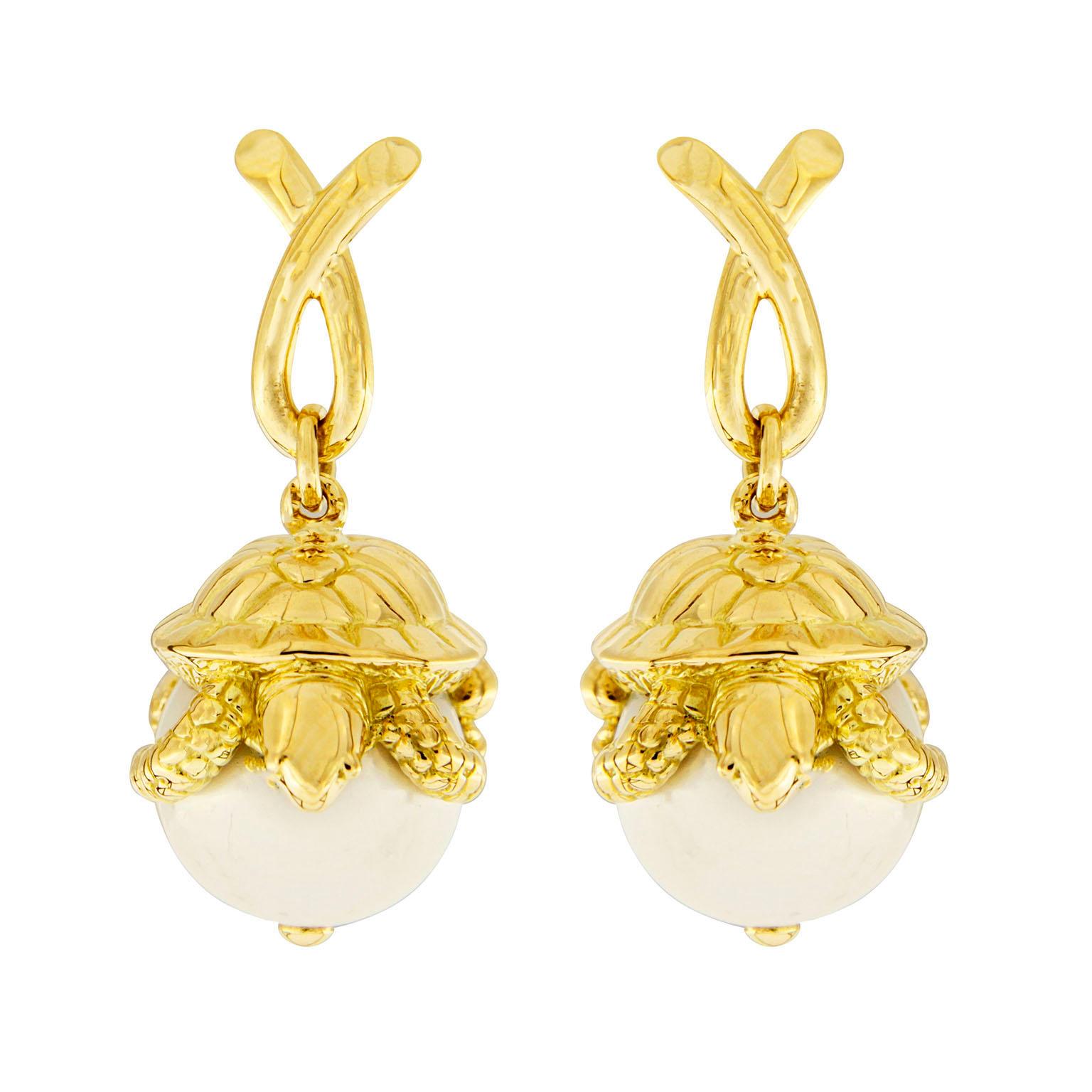 Turtle Sitting on South Sea Pearl Earrings connect animals and jewels of the water. The animals are shaped in 18k yellow gold which features everything from eyes to shell ridges and even claws. They peer down from their perch atop white South Sea