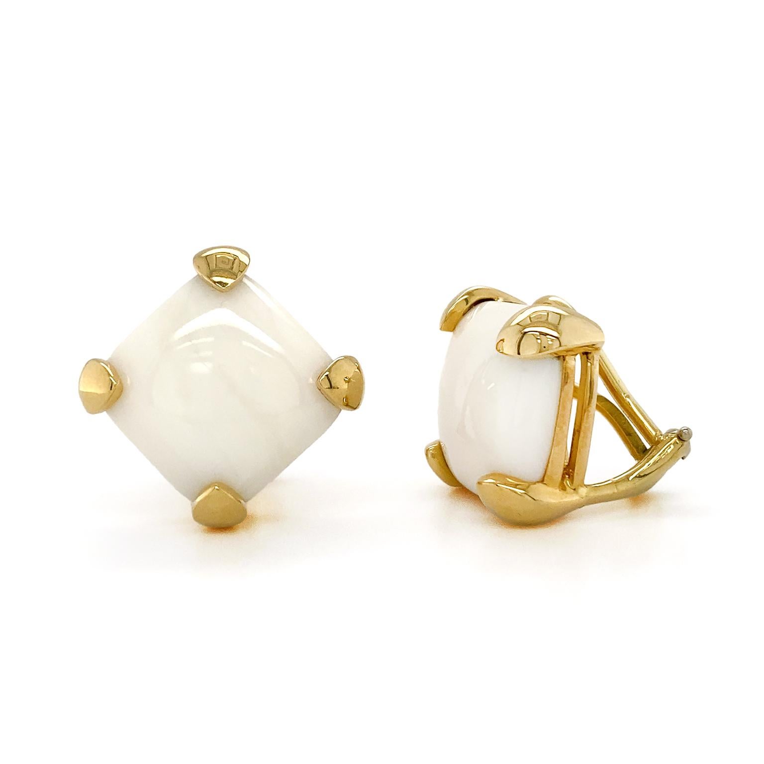 Jewels from the sea star in these earrings. The gem of choice is white coral, carved into cushion shaped cabochons. Subtle mottling plays across their surfaces. The coral is set rhombus wise with 18k yellow gold prongs hugging each corner. The