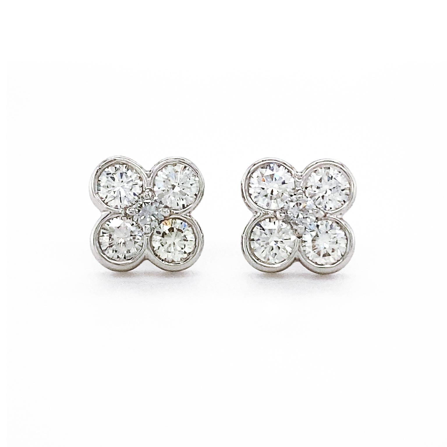 The silhouette of a four leaf clover is evoked from clusters of diamonds. Five round brilliant cut diamonds are nested together, four to represent each leaf and one in the center. These bright gemstones are EF color grades with VS clarity and have a