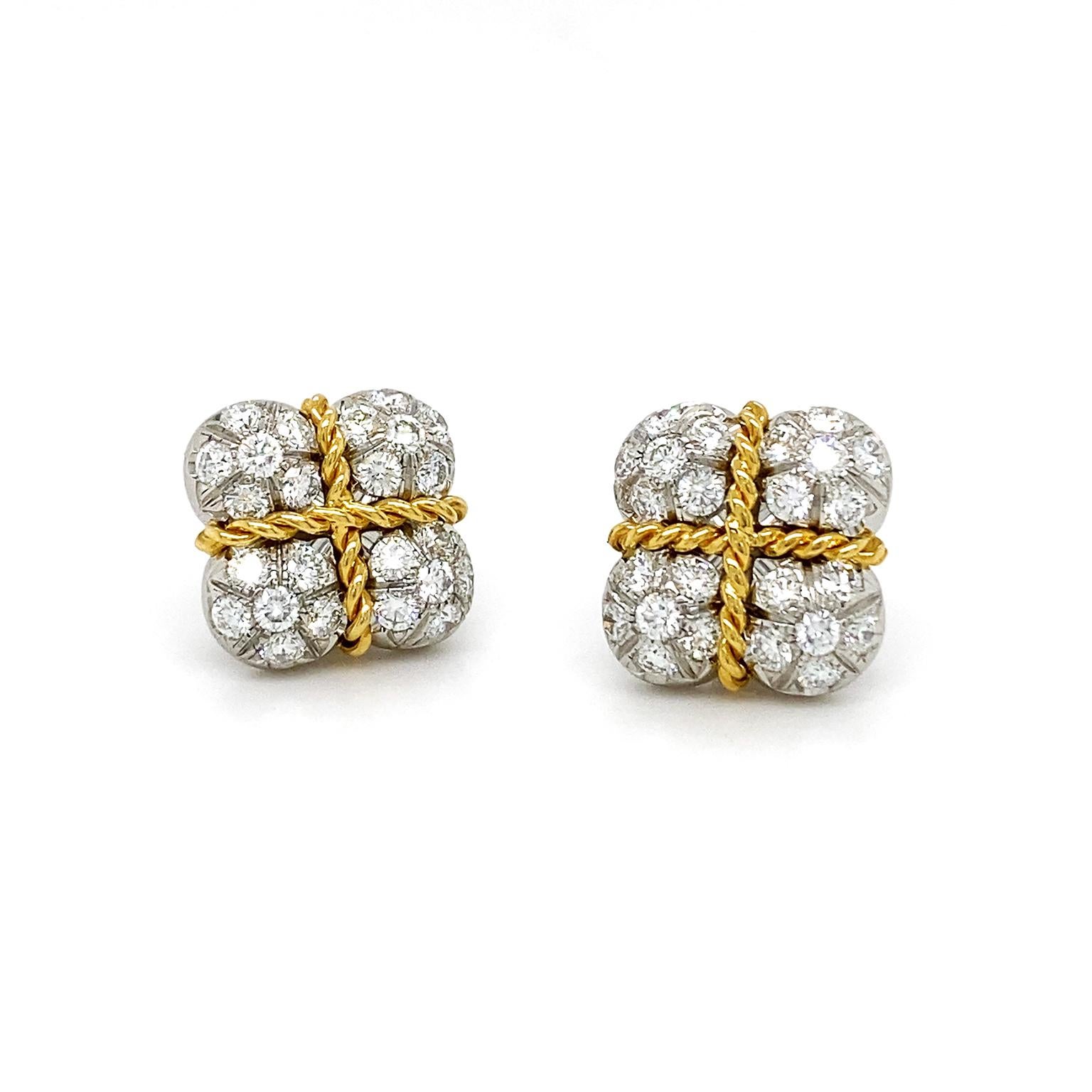 Inspired by a wrapped gift, these earrings beam with radiance. Set in platinum, glittering brilliant cut diamonds illustrate the gift box. 18k yellow gold braids overlap to represent a snug string, forming rounded quadrants of diamonds, which total