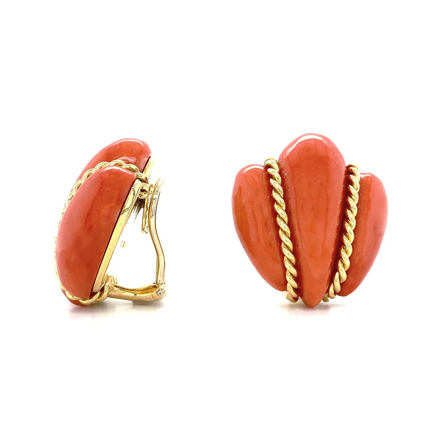 Vibrancy of red orange coral is showcased in these earrings. The repurposed gem is carved into a tapered shape with a trio of rounded tips. The center is raised higher and 18k yellow gold braids rest along each side of it. This forms an illusion of