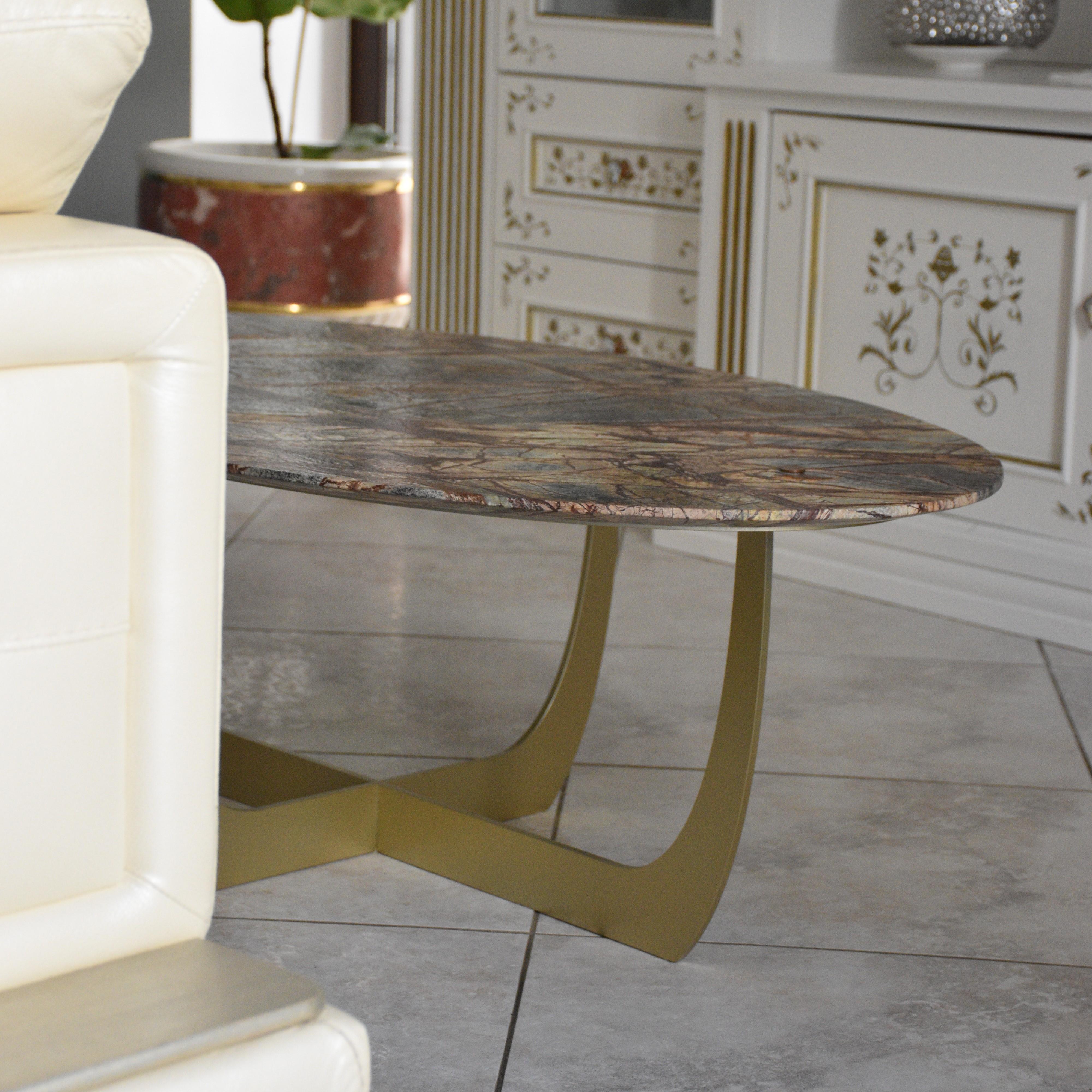 Valentine, a table for the living area that features a metal base with symmetrical, sculptural shapes that give the table a contemporary appeal. 
This coffee table boasts a clean, elegant aesthetic of timeless sophistication.
The top, made of