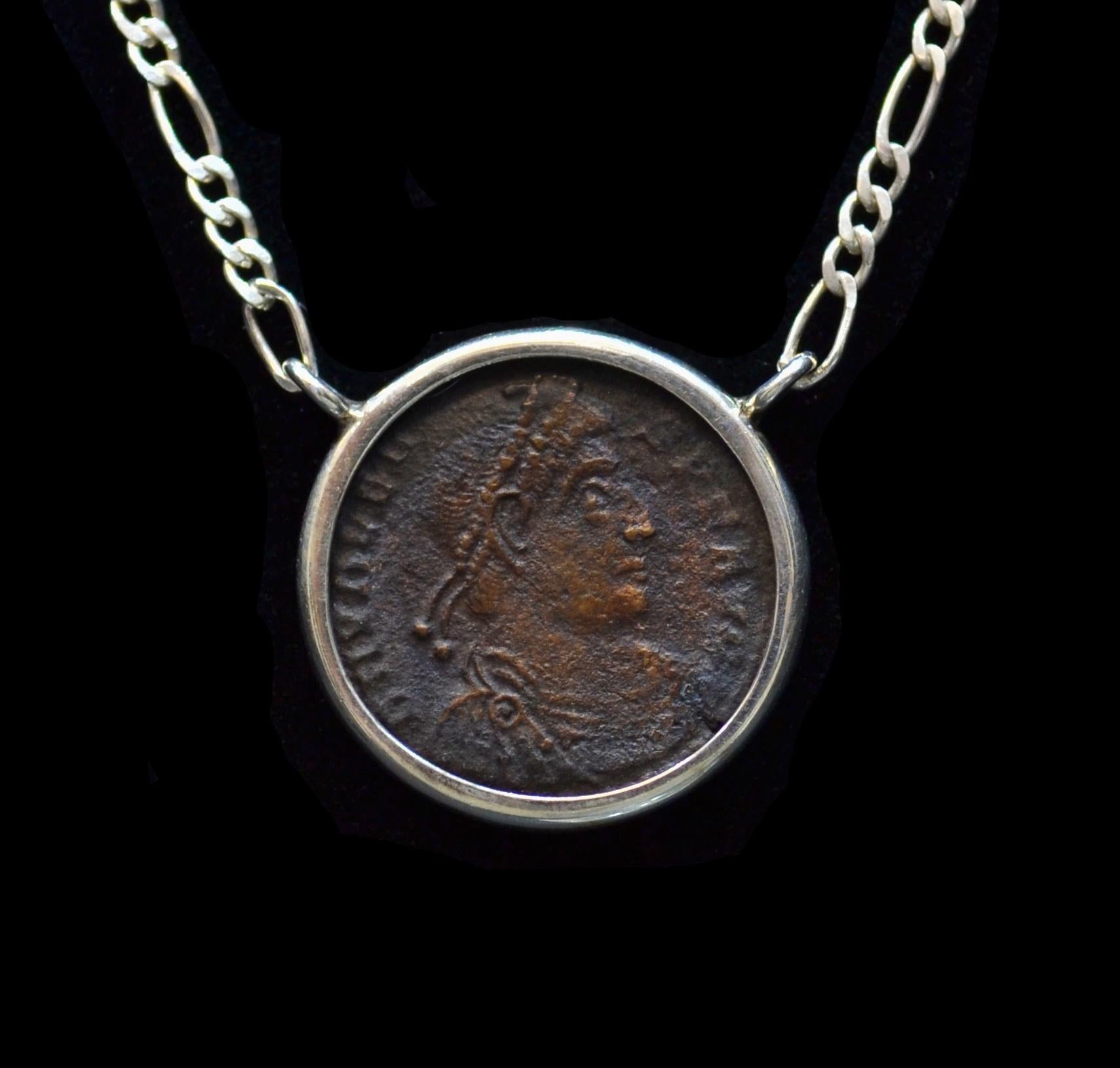 Authentic Roman bronze coin ca. 364-375 CE  mounted on contemporary silver necklace. Ready to be worn!

Also known as Valentinian the Great, upon becoming emperor he made his brother Valens his co-emperor, giving him rule of the eastern provinces.