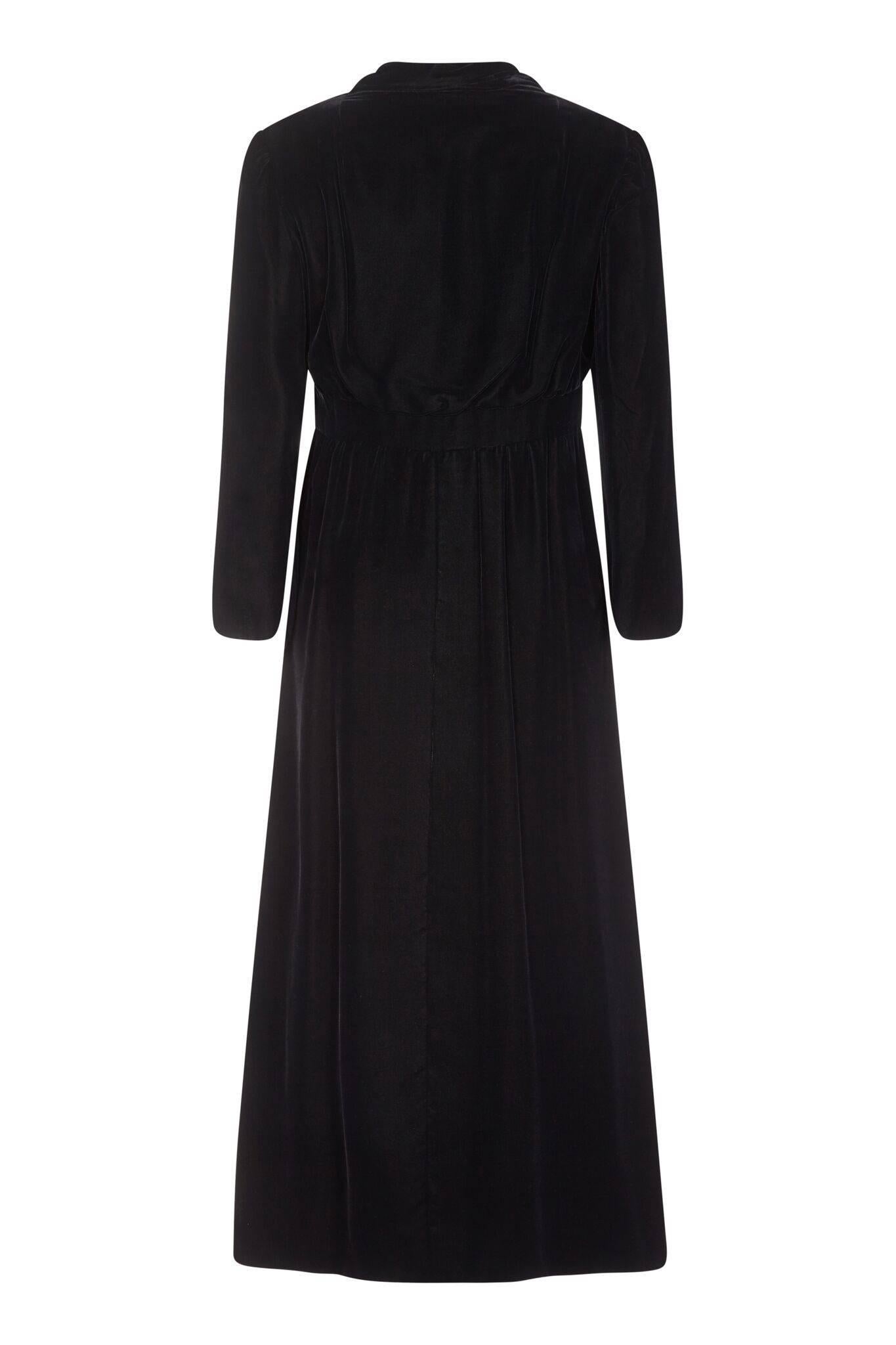 This elegant Valentino 1960s coat was an early collaboration with the then chic department store Debenham and Freebody who were licensed to reproduce his celebrated couture designs. The floor sweeping coat is made of luxurious black velvet and silk