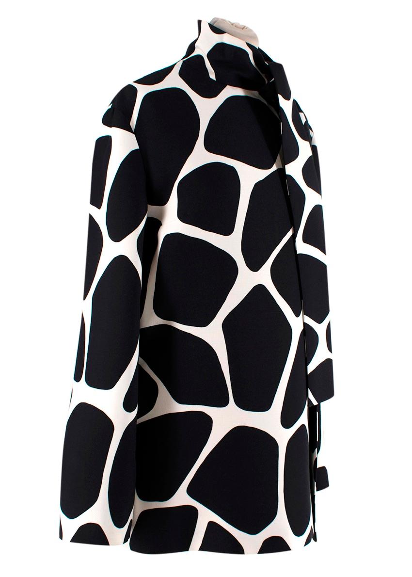  Valentino 1966 Giraffe Print Tie-Neck Tunic Blouse
 

 -The monochrome giraffe print blouse features an oversized bow tie at the neck
 - Concealed zip closure at the back
 - 60's/70's aesthetic 
 - Resort 2020 collection 
 

 Materials 
 65% Virgin
