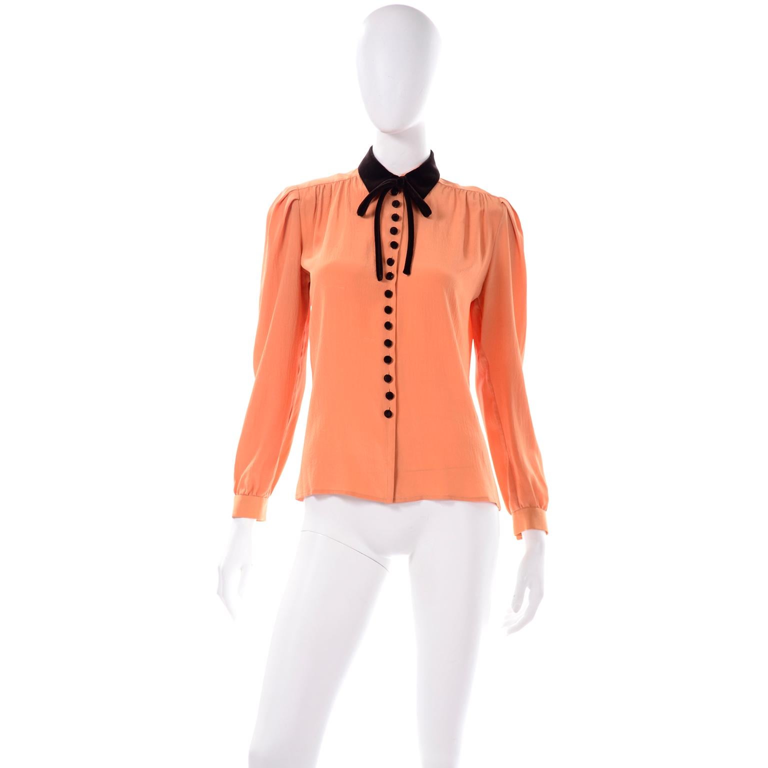This is an exquisite Valentino Boutique vintage orange silk blouse with a brown velvet collar, brown tie and brown velvet fabric covered buttons. We love the pretty gathers t the shoulders and the lovely way the blouse fits. This piece came from an
