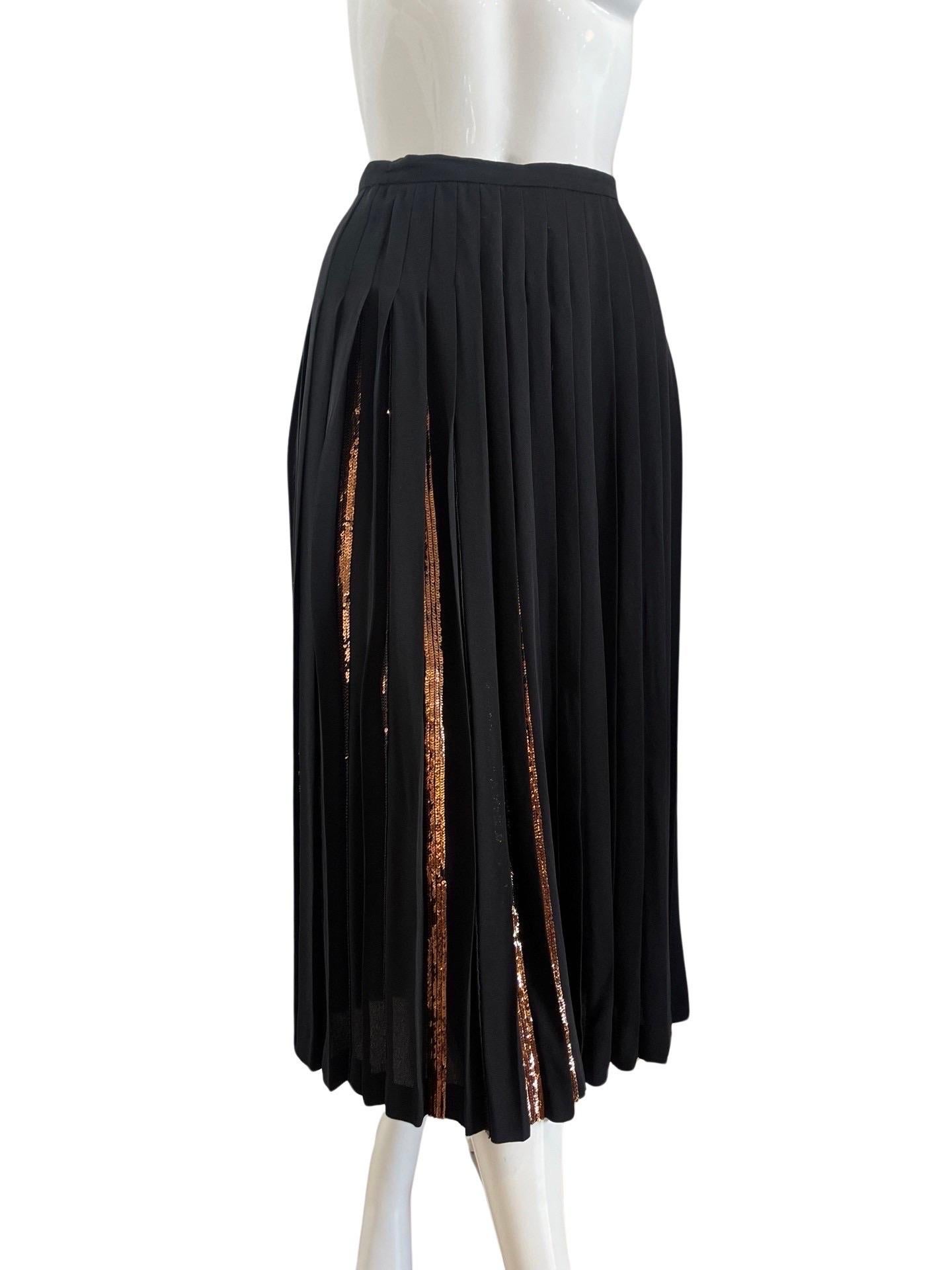 Beautiful 1980s Valentino pleated skirt with copper colored sequins inside the pleats. The beauty is in how this skirt moves and reveals the sequins and the copper color sequins are very beautiful.  The label on this skirt says a size 8, but the