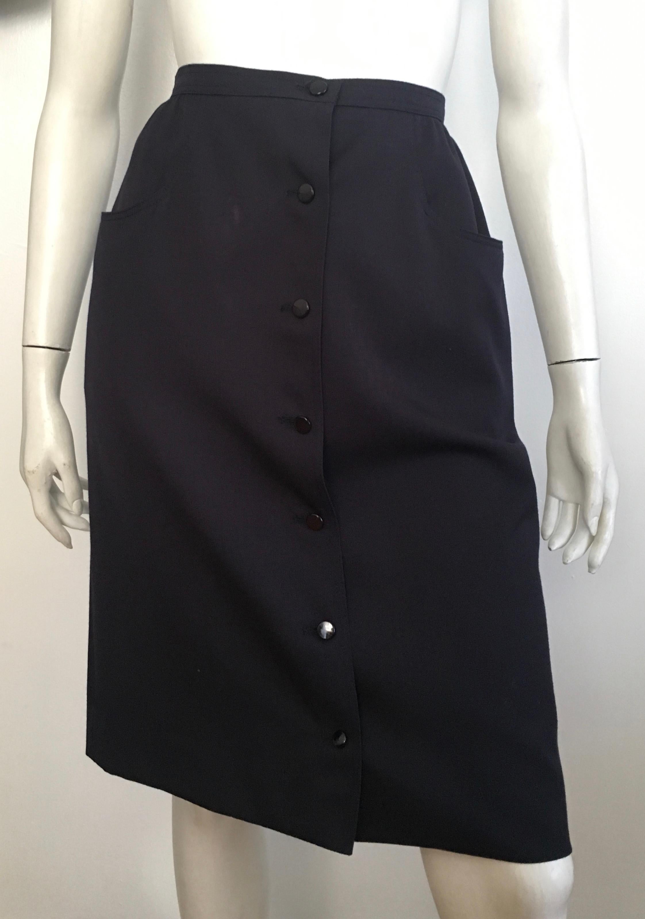 Valentino Boutique 1980s navy wool button wrap skirt with pockets is labeled a size 12 but fits like a modern size 6 / 8.  The waist on this skirt is 29. 1/2