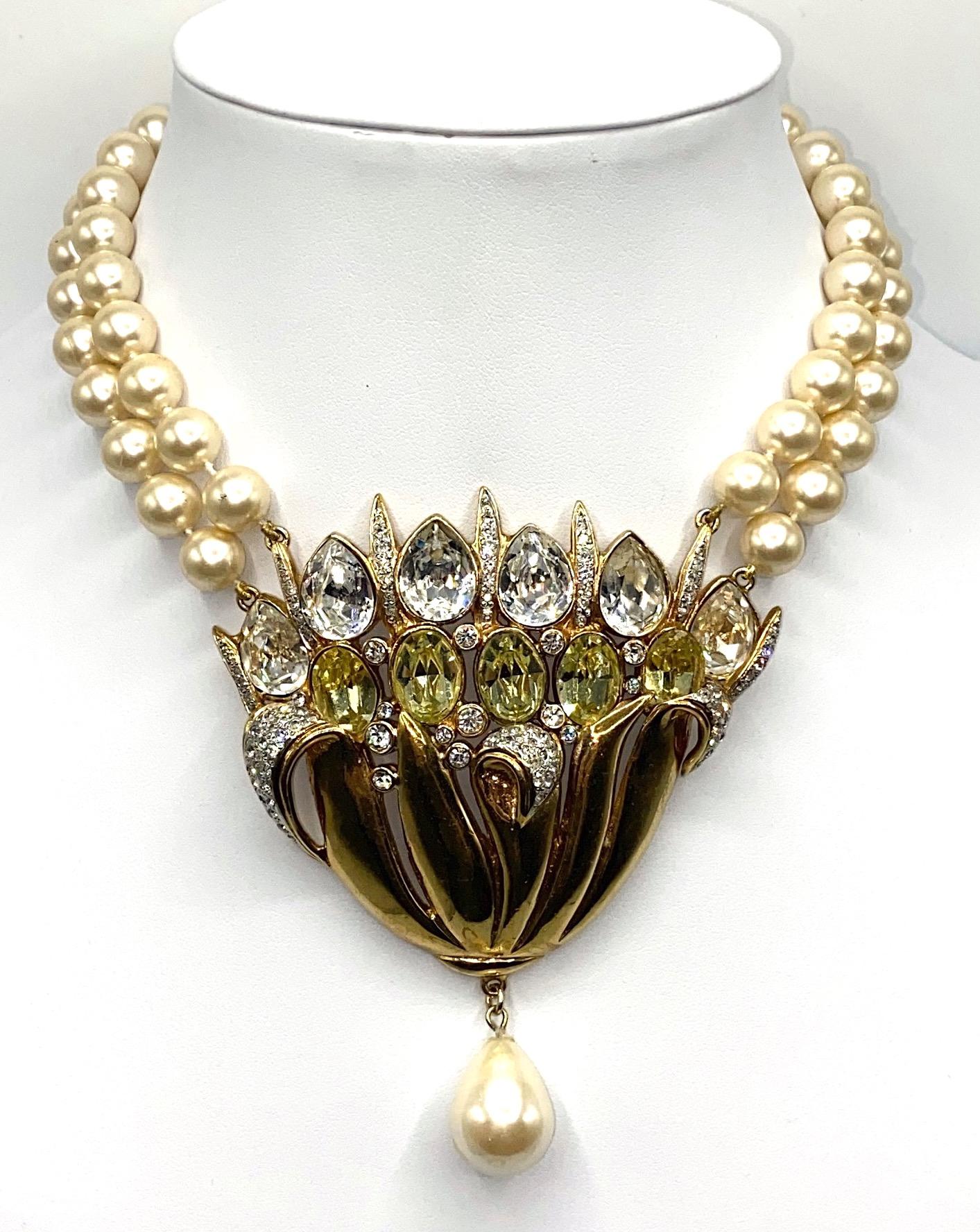 Presented is an exceptional 1980s necklace from the the Italian fashion house of Valentino Garavani. Two stands of individually knotted faux glass pearls support the large statement center piece of a flower. The center piece is lightly domed and