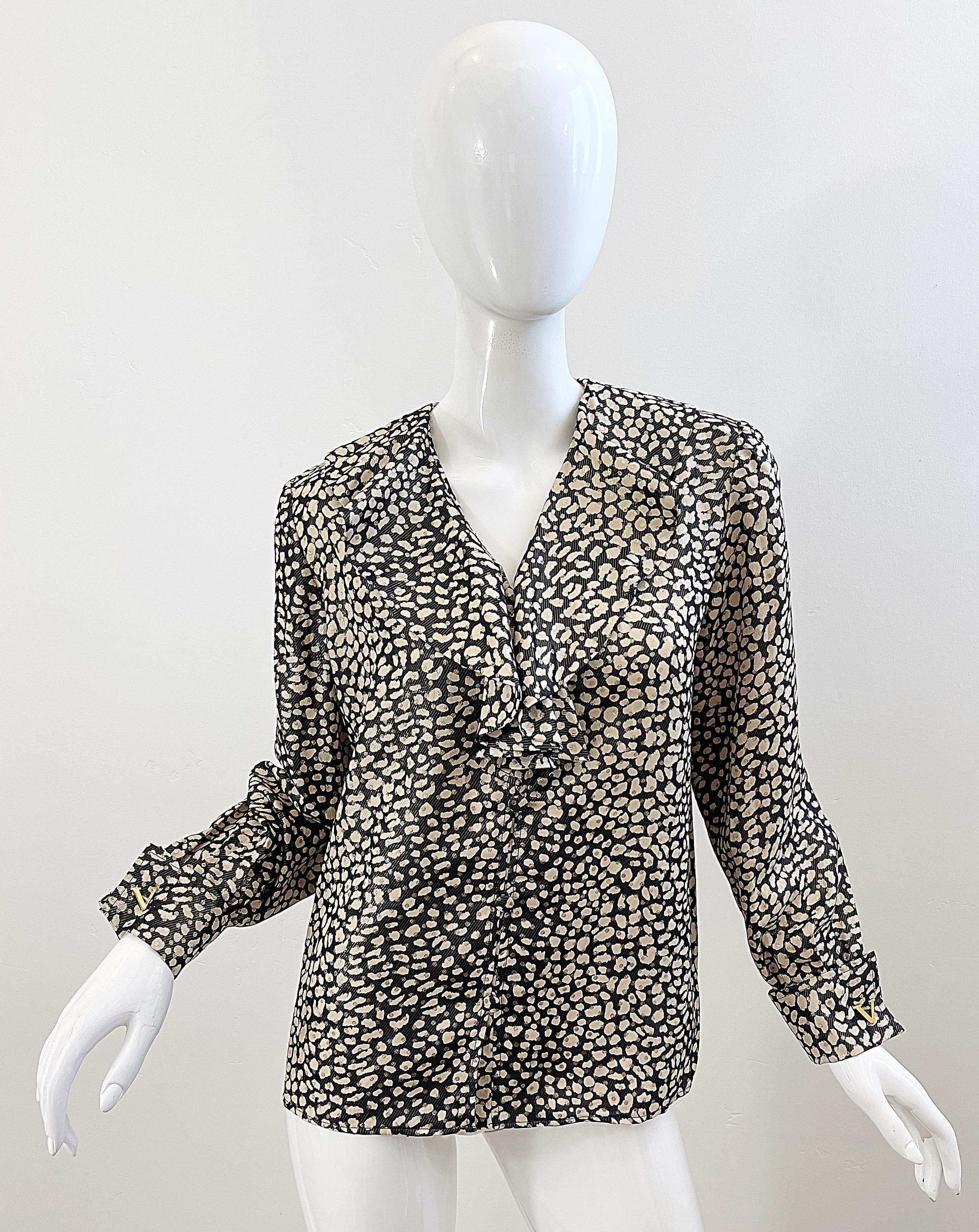 Chic vintage 90s VALENTINO MS V leopard animal print silk top ! Features black, ivory and gold metallic throughout. Gold V logo cufflinks at each sleeve cuff. Buttons up the front with ruffles around the neckline. 
Pair with jeans, trousers, shorts