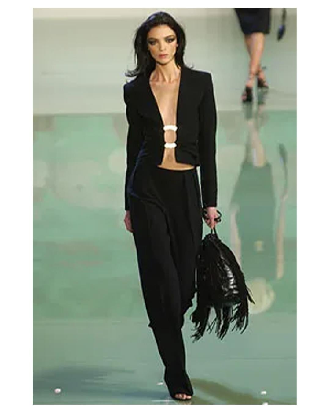 LOVE LALI Vintage

Valentino Spring 2003
This is the most gorgeous head turning jacket! Incredibly sexy to team with dress pants
Collarless long sleeve black fitted jacket with an open plunging neckline
The jacket closes via an oversized brass