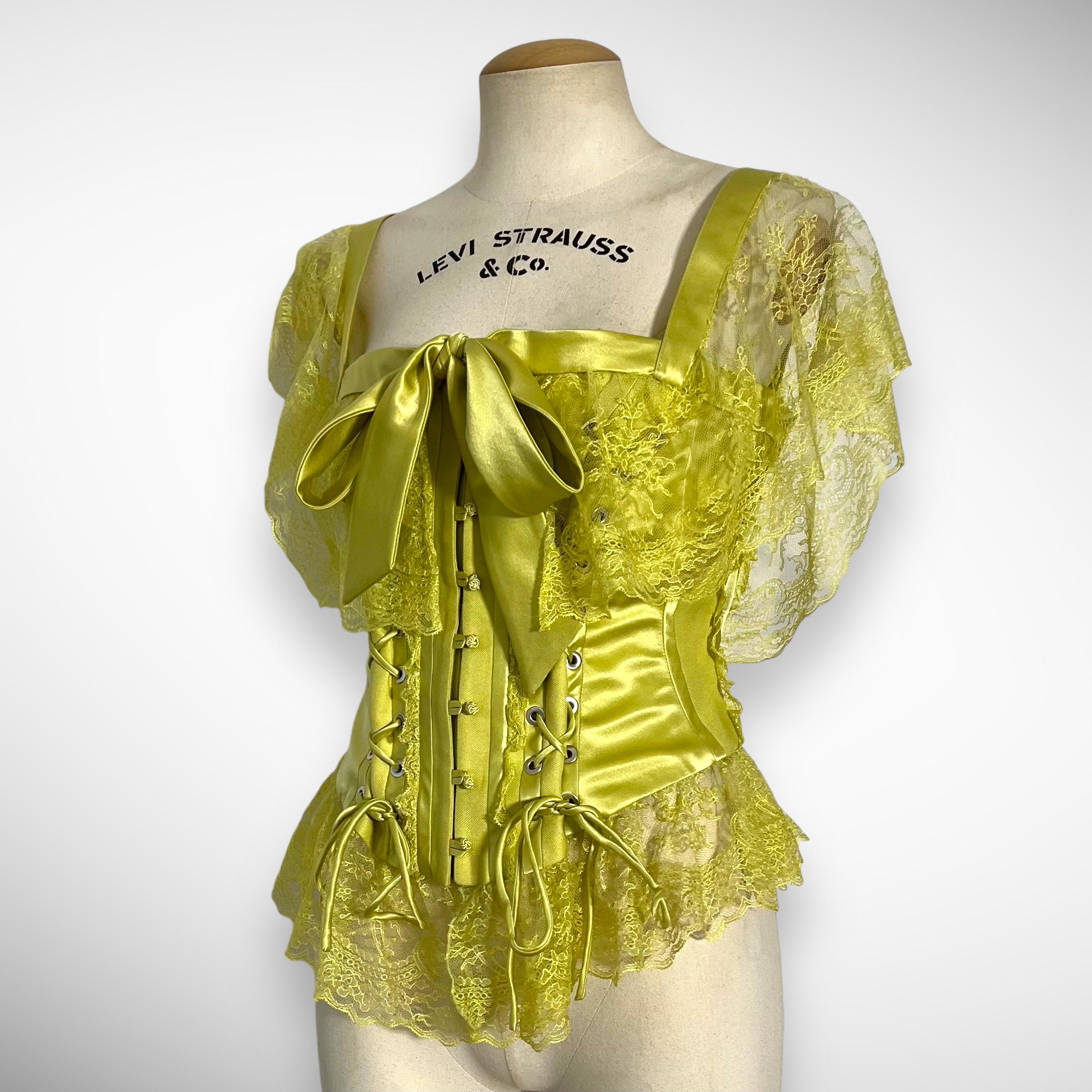 2004 Runway green valentino corset. 

Valentino is a renowned Italian fashion house founded by Valentino Garavani and Giancarlo Giammetti in 1960. Over the years, several talented designers have contributed to the brand's legacy, including Maria