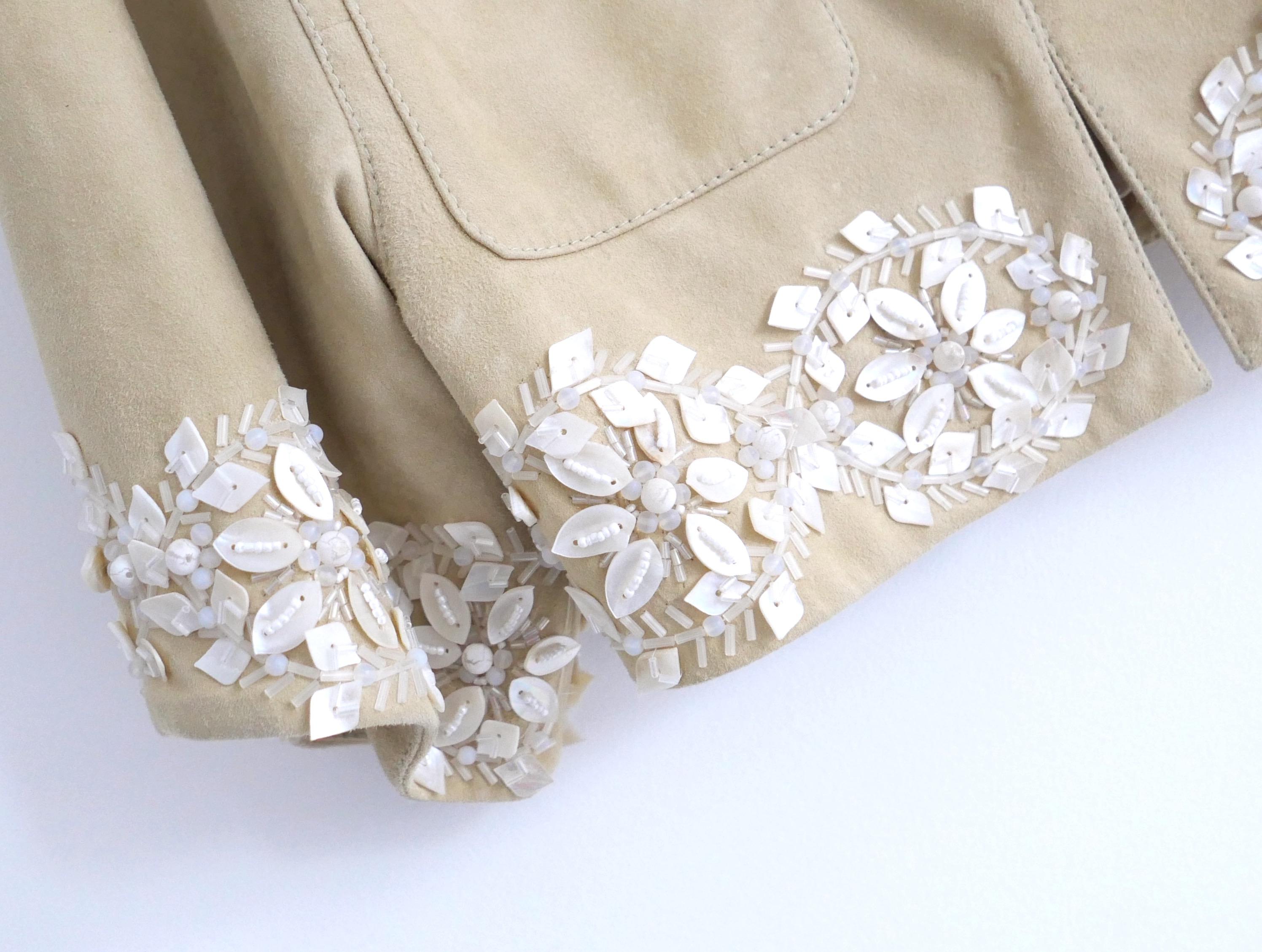 Absolutely incredible vintage Valentino suede jacket from the Spring 2005 collection. Unworn with tags. Made from buttery soft sand coloured goat suede with stunning hand crafted mother of pearl and shell embellishments. It has a relaxed safari