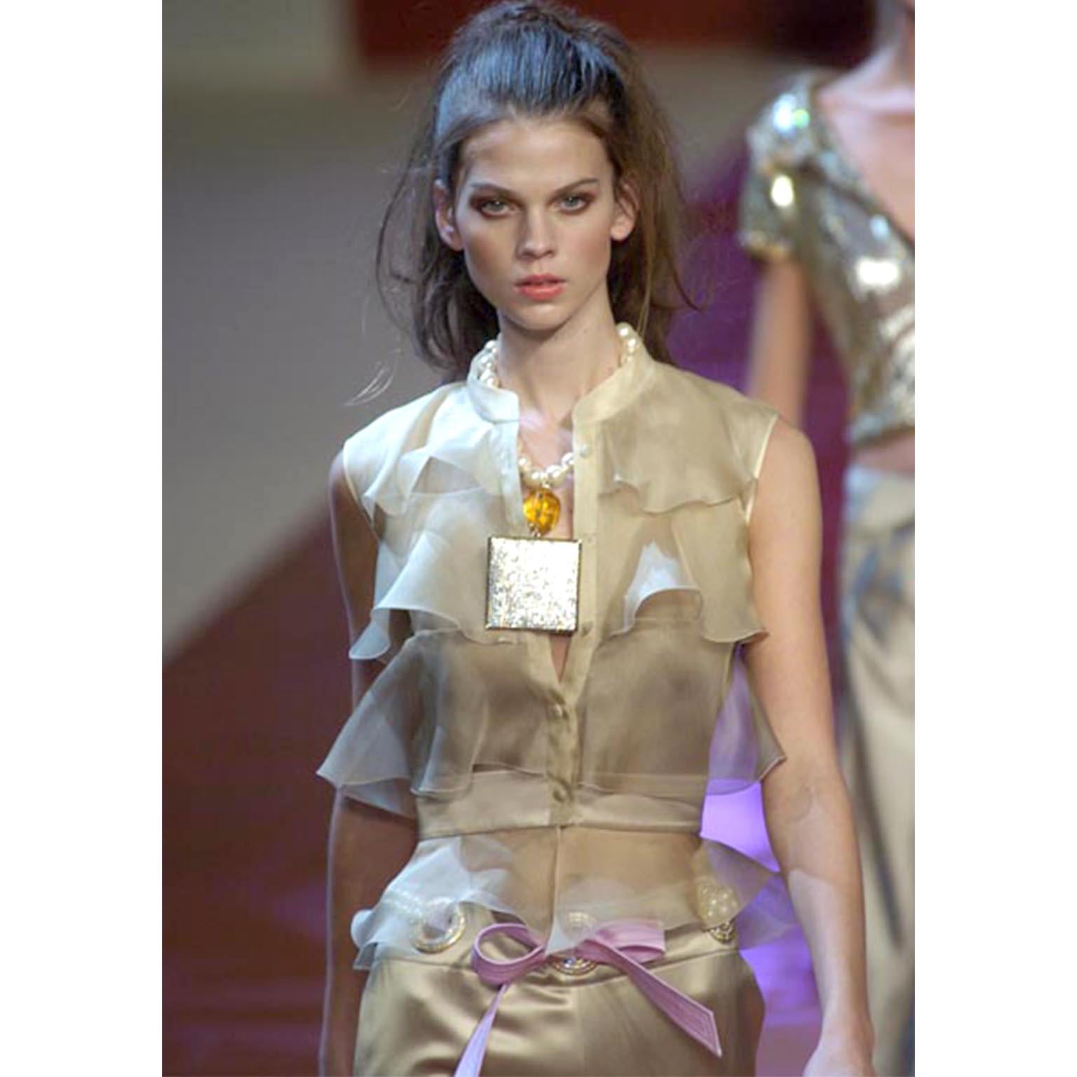 We love Valentino and this elegant top was designed by Valentino Garavani for his S/S 2005 collection. This incredible top was featured on the runway in a variety of colors and we have it in 3 different shades as well. We currently have a green one