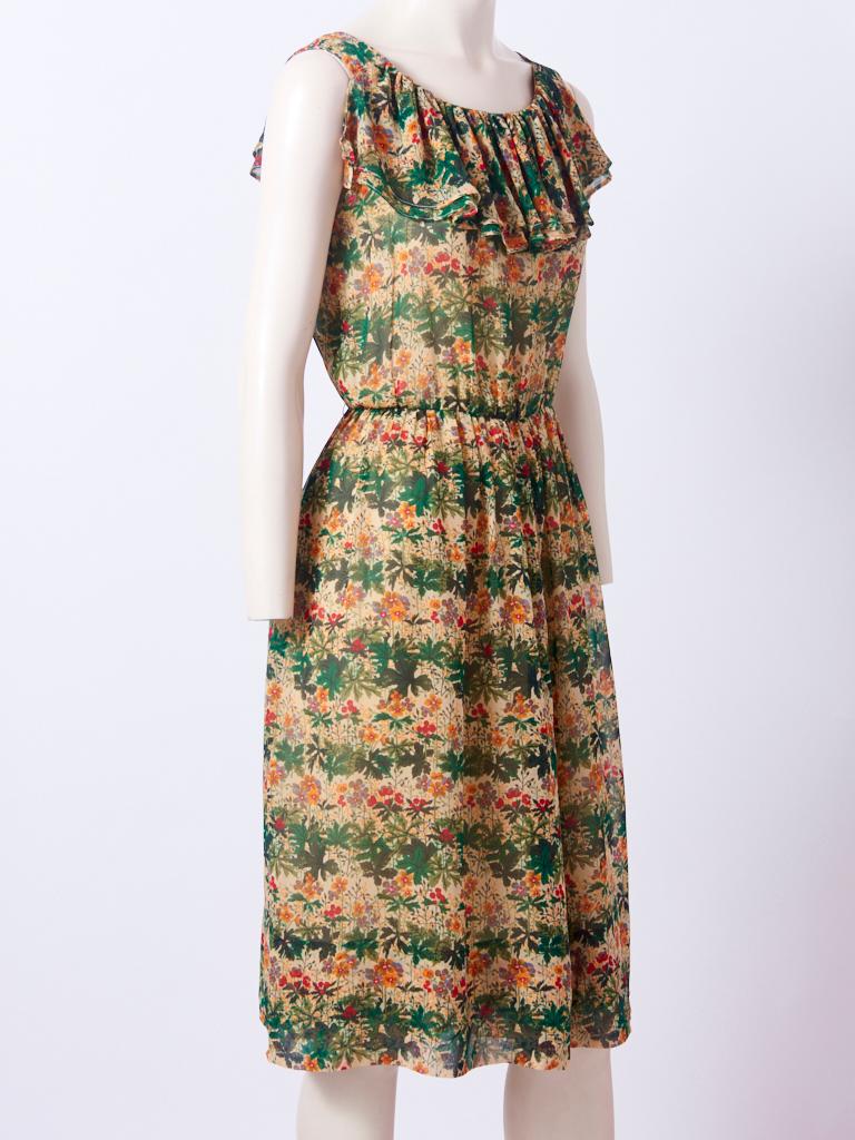 Valentino, printed chiffon, sleeveless day dress, having a scoop neckline with a double layer flounce detail. Soft gathering at the waist. Dress is lined in a nude tone chiffon.
