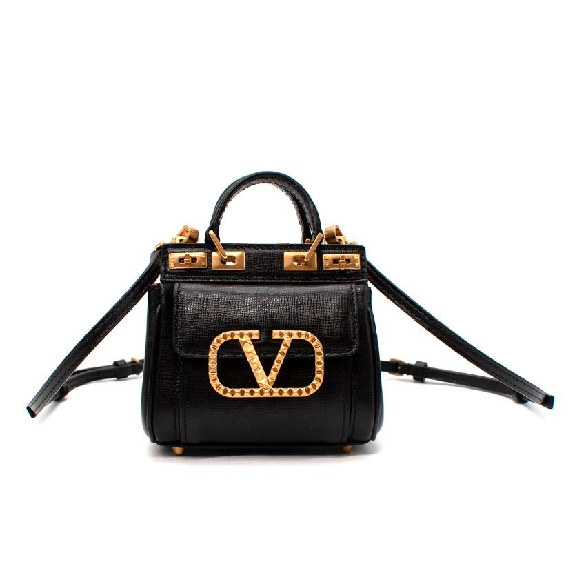 Valentino Alcove Micro V-Logo Grained Leather Tote

- Micro Alcove tote style rendered in textured calf leather
- Gold-tone hardware, including a Rockstud'ed Vlogo plague to the front 
- Miniature turnlock closure on each side, with 2 internal