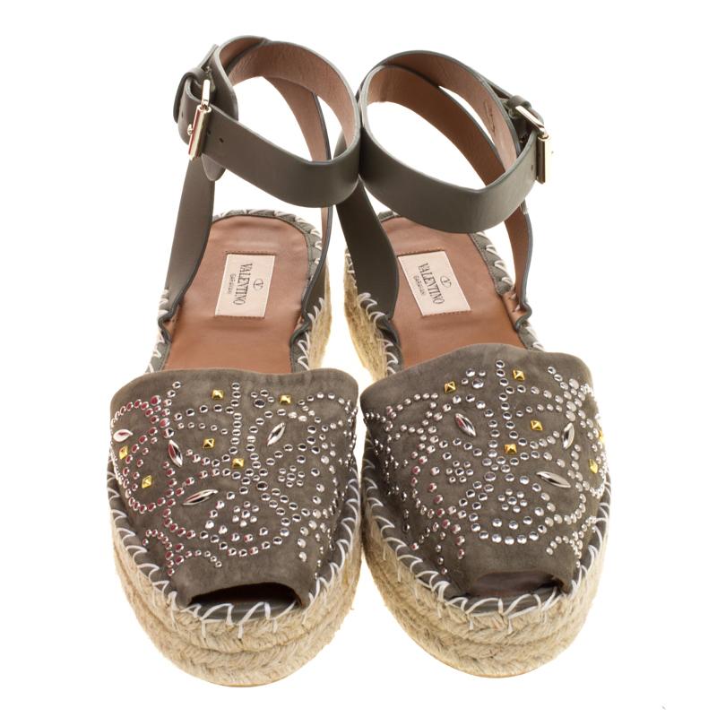Step out in style with these trendy espadrilles from Valentino. Featuring a pretty embellished exterior, this peep-toe pair is completed with braided details on the midsole and leather ankle straps. This pair will be perfect with dresses and shorts
