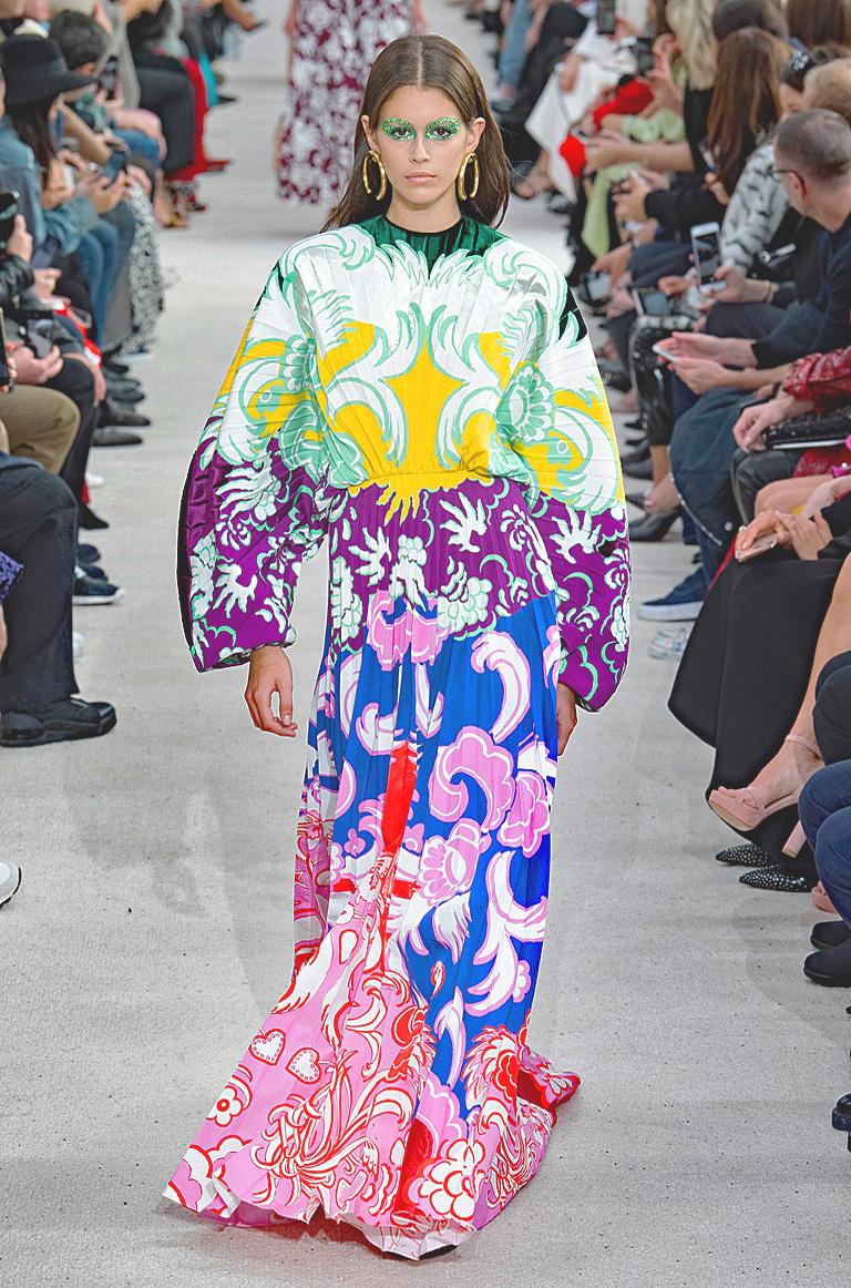 A stunning Valentino demi-couture long dress, offering a  mosaic of colorful print patterns inspired by Matisse and Gauguin.   The dress construction combines some pattern pieces separately stitched  onto the skirt.  Lightly pleated bodice boasts