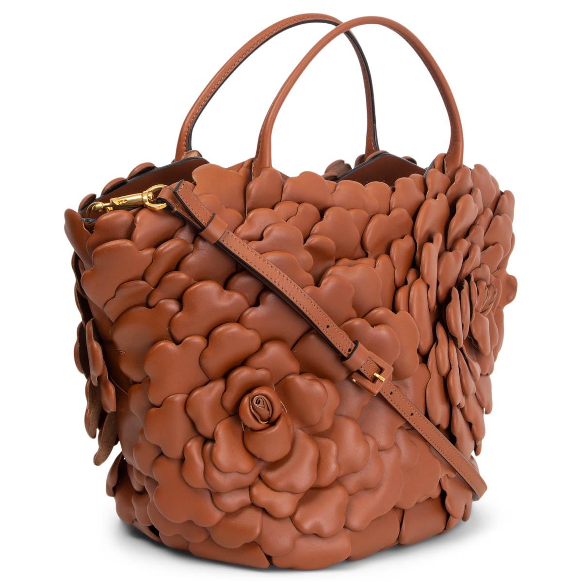 100% authentic Valentino Garavani 03 Rose Edition Atelier Small Tote Bag in cognac brown nappa leather embellished by leather petals creating a 3D rose detail. Comes with an adjustable strap with two buckles. Open top, strap fastening got removed.