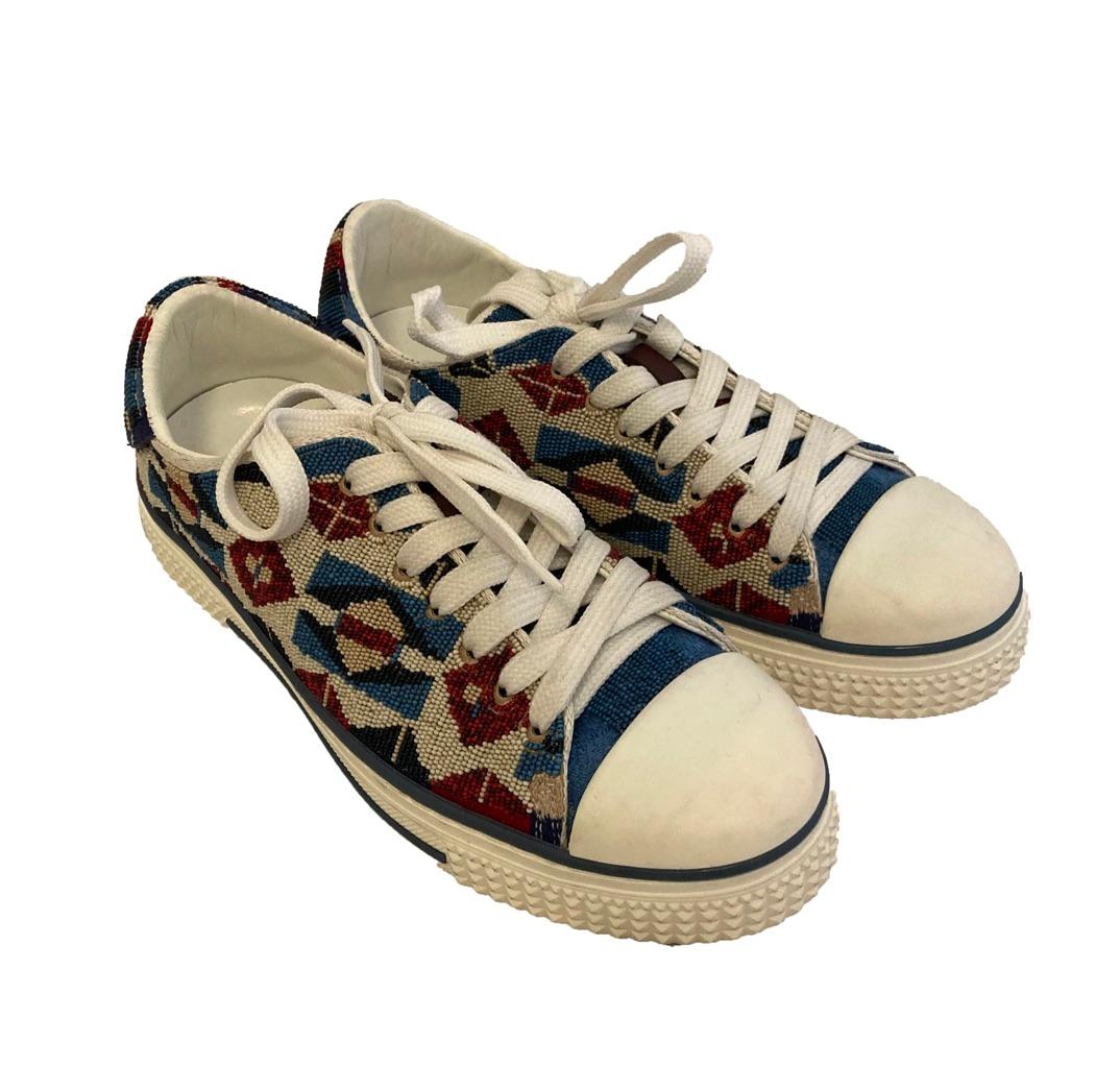 Beautifully beaded Aztec style sneakers from Valentino Garavani. 

Dark blue, sky blue, cream red and crimson intricate beading all over the sneakers which forms an aztec style pattern. With rounded white rubber toes and a 3cm white rubber sole