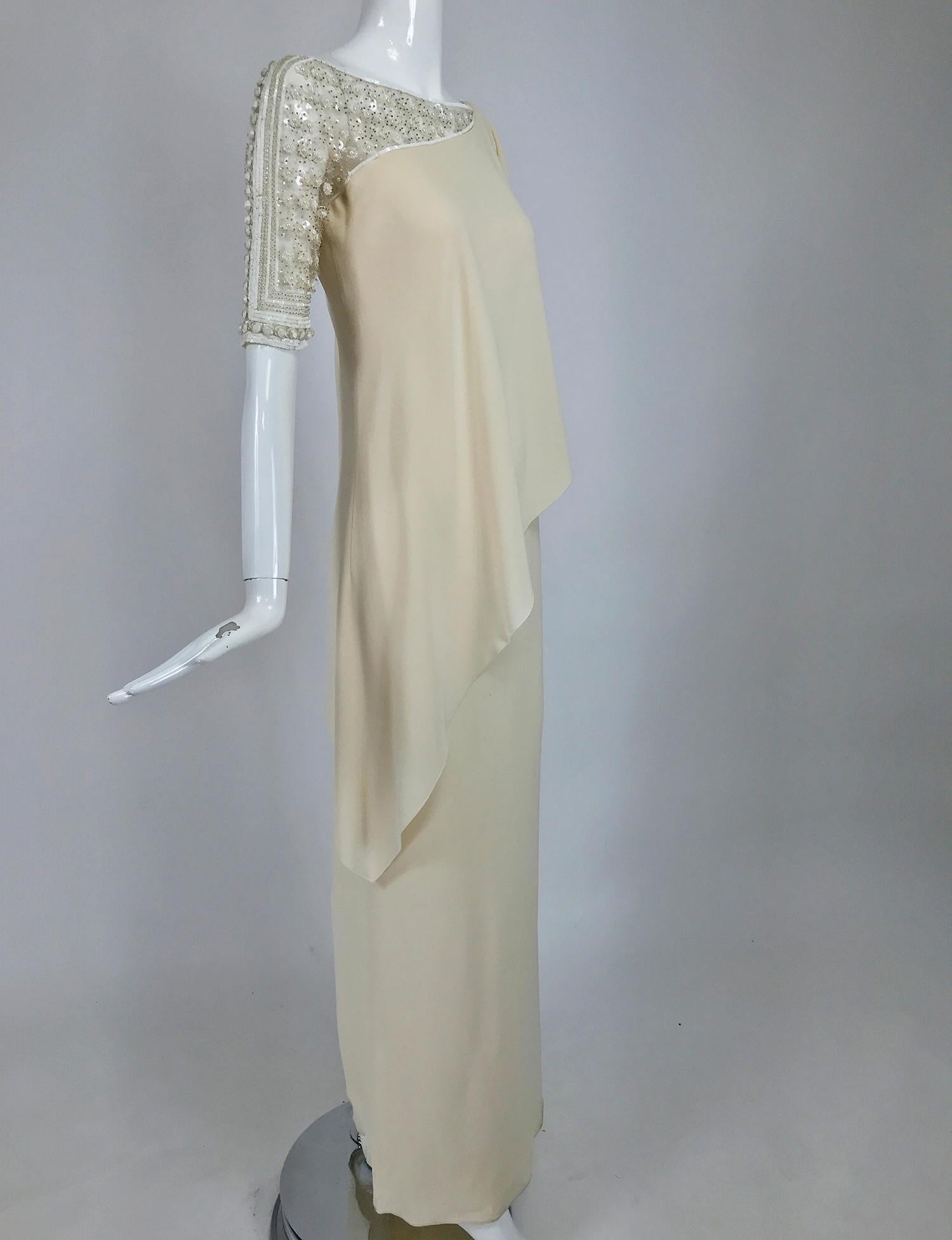 Valentino off white beaded draped runway gown as worn by Princess Marie-Chantal of Greece for Valentino's 45th anniversary celebration in Rome 2007. 
Classic simplicity, this dress features a hand beaded upper bodice front and back with a beaded