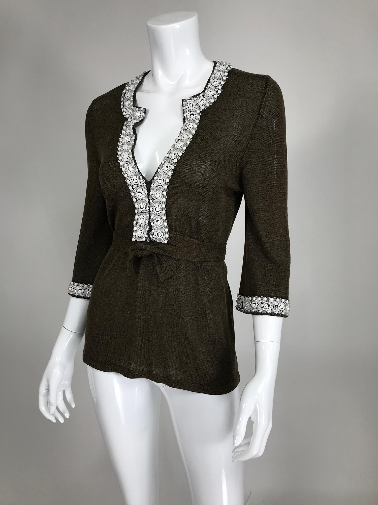 Valentino beaded knit, plunge V neckline top in brown. White & crystal beads and sequins trim the neckline and cuffs. Pull on top has 3/4 length sleeves and waist wraps. Silky rayon knit. Unlined. Marked size 42/6. 
     In excellent wearable