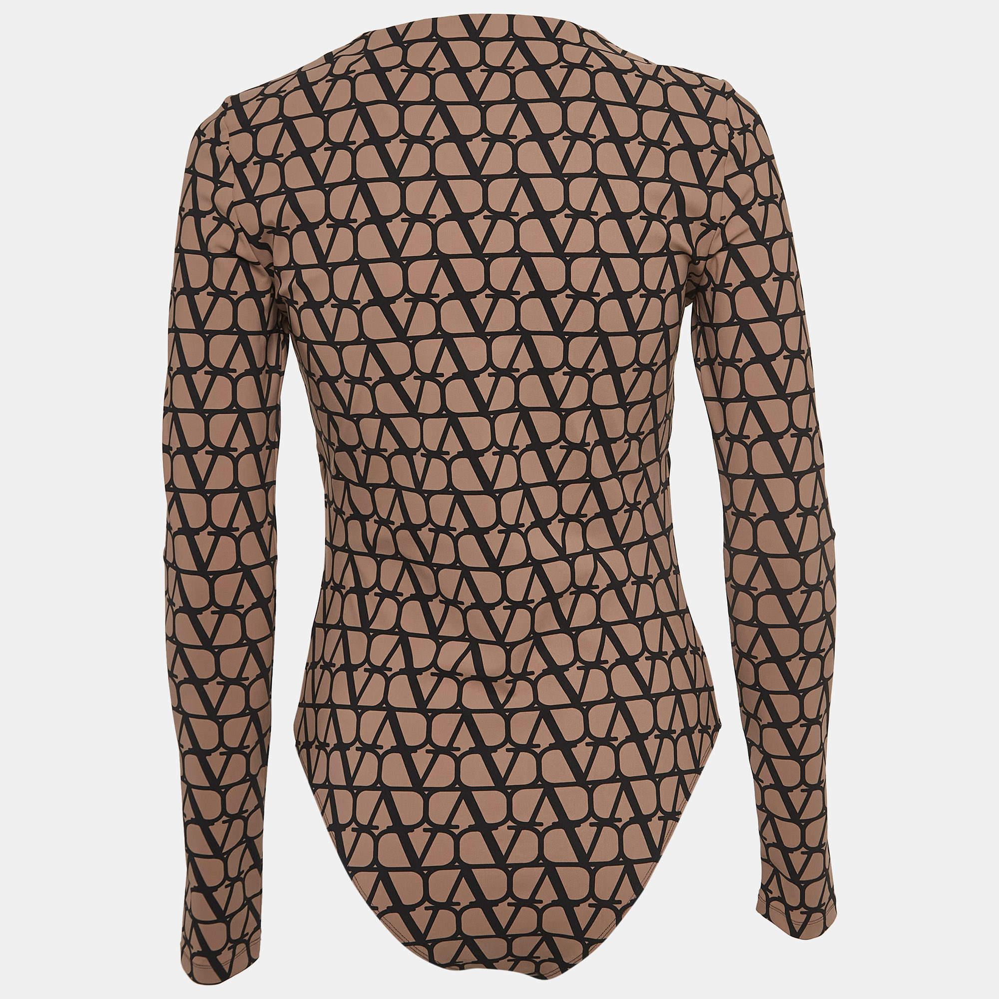 Experience effortless chic with the Valentino bodysuit. Crafted with meticulous attention to detail, this bodysuit features a timeless beige and black monogram print on soft jersey fabric. The long sleeves add versatility, making it perfect for both