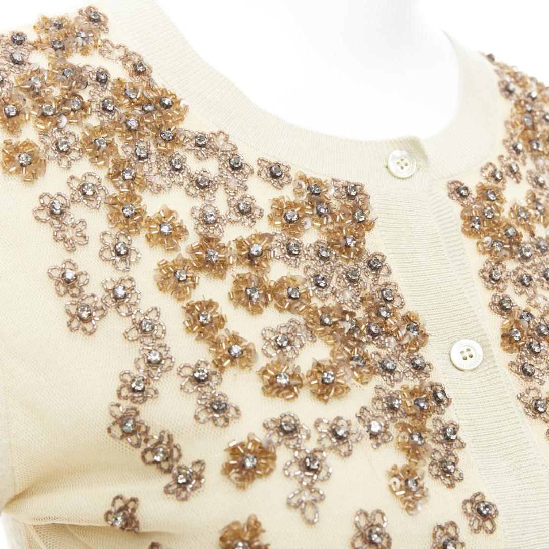 VALENTINO beige cashmere silk bead embellished crop cardigan M
Reference: CC/A00440
Brand: Valentino
Material: Cashmere, Silk
Color: Beige, Silver
Pattern: Floral
Closure: Button
Extra Details: Mesh overlay at front with floral embellishments.
Made