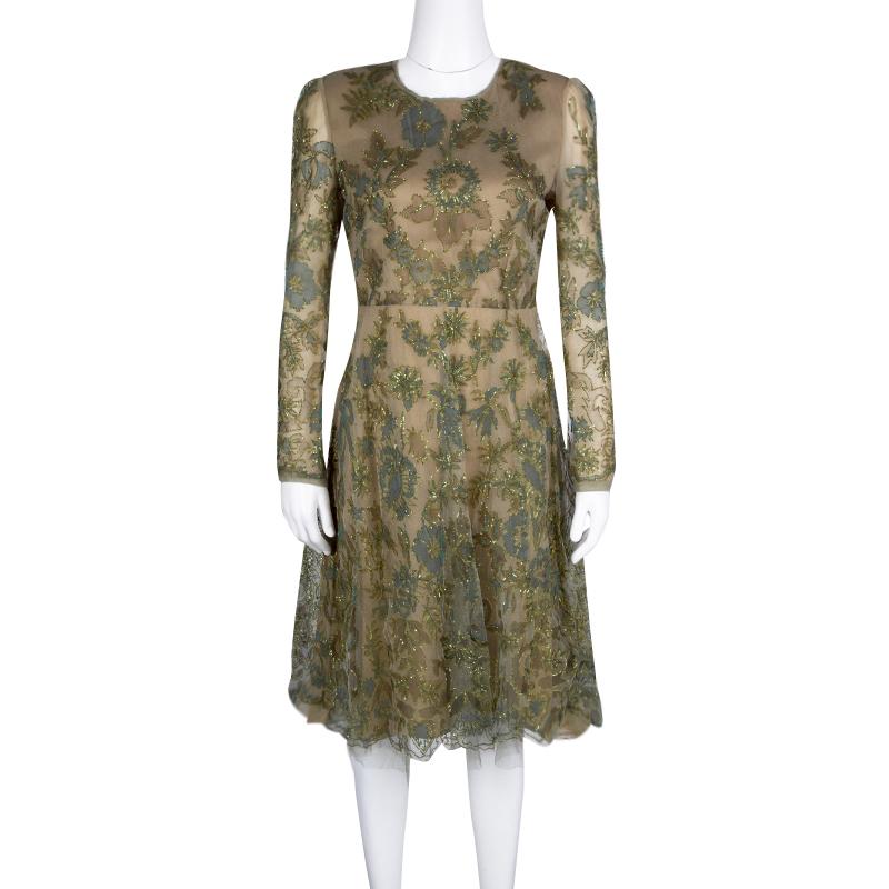 A perfect dress to get your ready for parties and special events, this Valentino cocktail dress is sure to steal your heart. Constructed in beige silk fabric, this dress features multicoloured prints all over along with metallic gold threaded