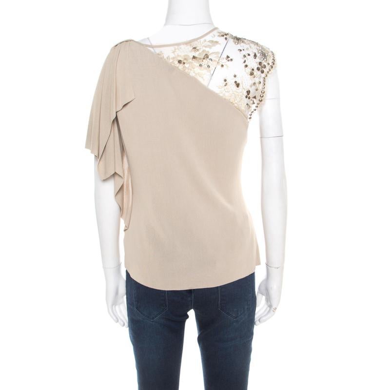 This beautiful beige top from Valentino is an absolute stunner that pairs well with any outfit variation you are looking for. It has floral lurex embellished sleeve detail that makes it super feminine and pretty. Mix and match this masterpiece