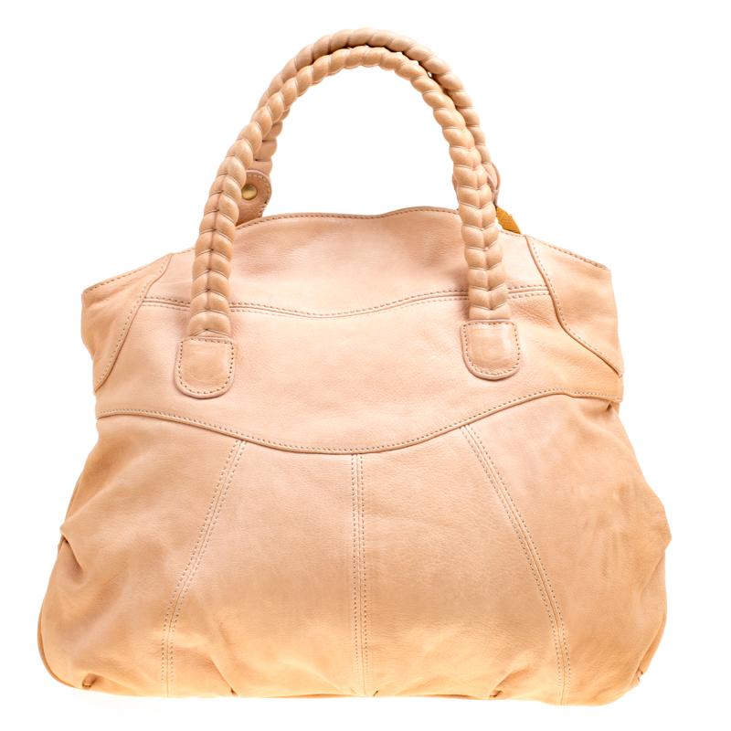 This tote from Valentino is smart and stylish. Crafted from beige leather it carries a braided detail on the front along with dual braided handles. The fabric lined spacious interior comes with a zip pocket and will hold all your belongings.

