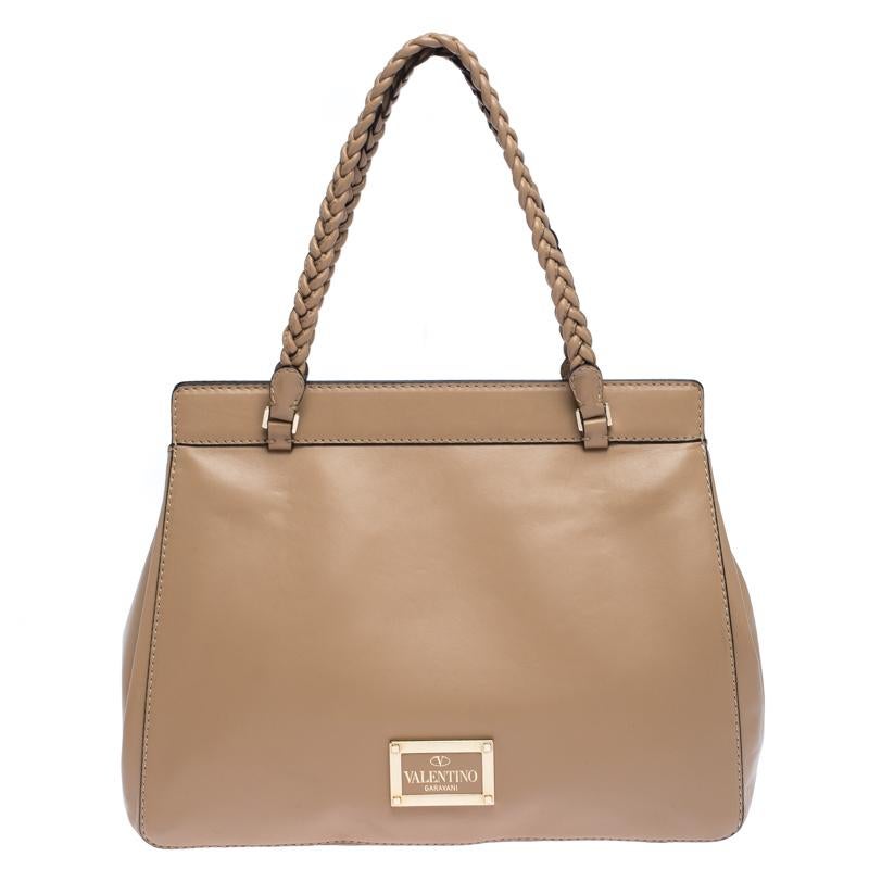 This beautifully stitched leather tote is by Valentino. With a capacious fabric-lined interior, it will house more than your essentials. Boasting two handles and a seamless finish, this tote offers style and utmost practicality.

Includes : Original