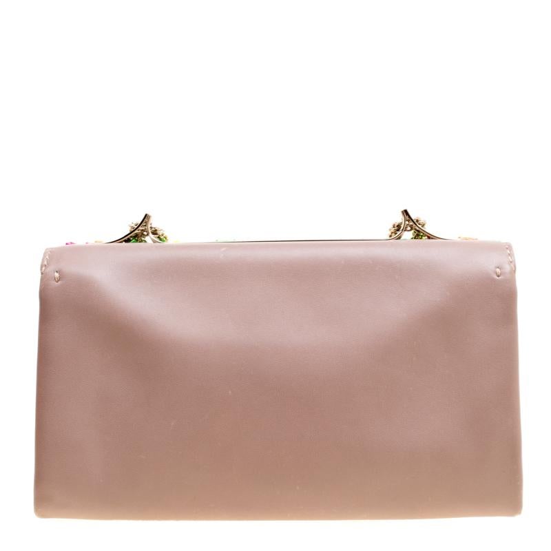 This Va Va Voom shoulder bag from Valentino has a pretty captivating design. Crafted from leather, the bag features gorgeous jewel embellishments on the flap, a leather interior, and a shoulder chain. It also comes with a hand slot that is decorated
