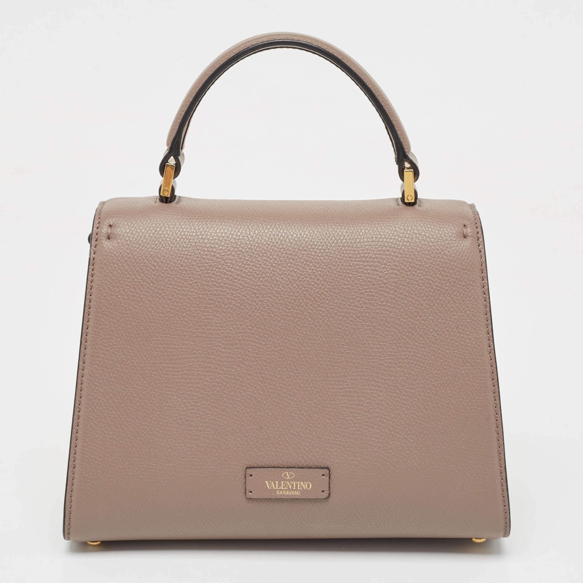 Classy in design and super easy to hold — in your hand, on your shoulder, or across the body — the Valentino VSling is rightly a coveted accessory. It has been crafted from beige leather and styled with a flap closure.

Includes: Info Booklet,