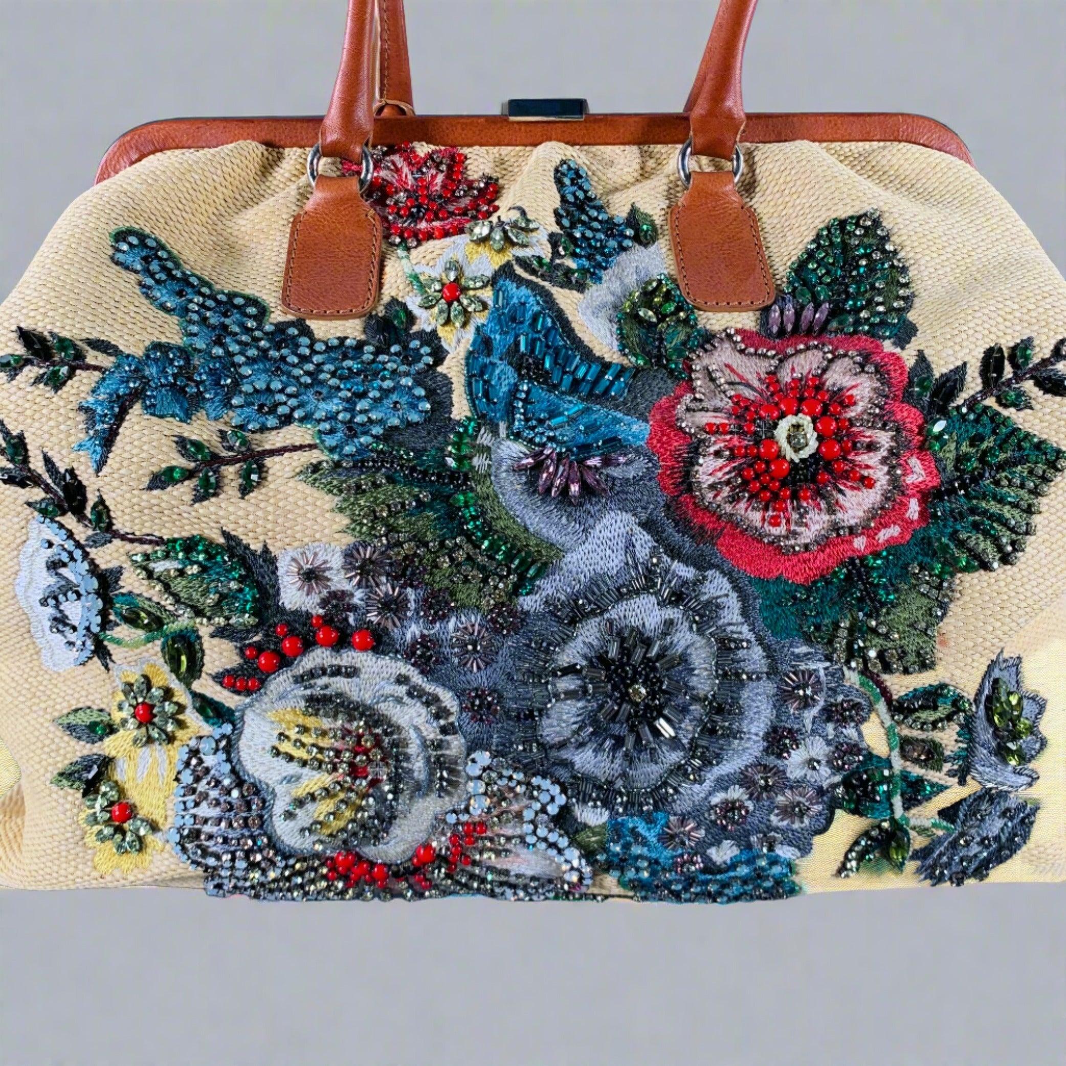VALENTINO handbag
in a beige woven raffia featuring a floral embroidered rhinestone design, and
brown leather top handles.Very Good Pre-Owned Condition. Some missing rhinestones. 

Measurements: 
  Length: 18.5 inches Width: 6 inches Height: 13.5