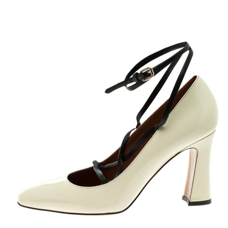 A perfect mix of elegant fashion and sensuous style, these Valentino pumps come crafted from leather and detailed with almond toes and lace-ups. They're visually stunning and they stand tall on 9 cm block heels.

Includes: Original Box, Original