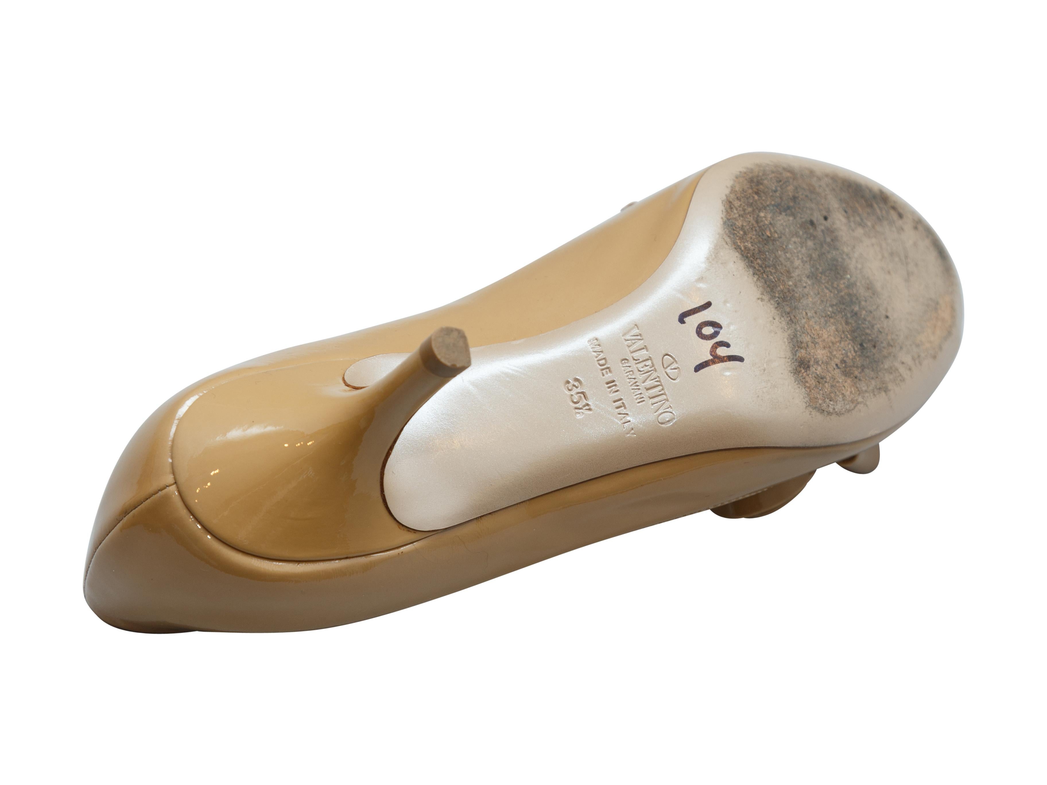 Product details: Beige patent leather peep-toe heels by Valentino. Bow accent at tops. Designer size 35.5. 2.5