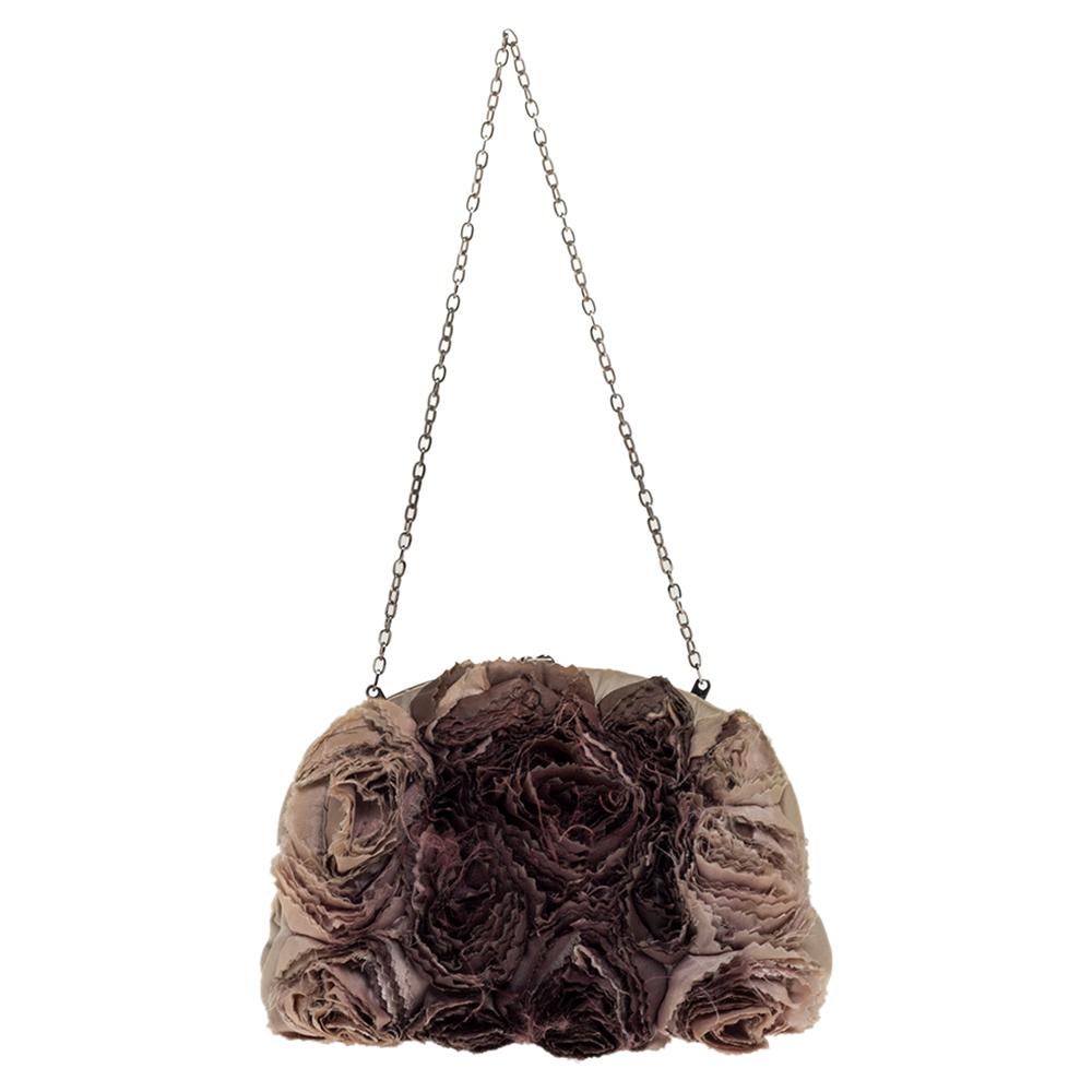This clutch from Valentino is designed with satin roses and crystals. It features a frame top and its satin interior is sized to hold your little essentials. It comes held by a chain and is perfect for evenings.

