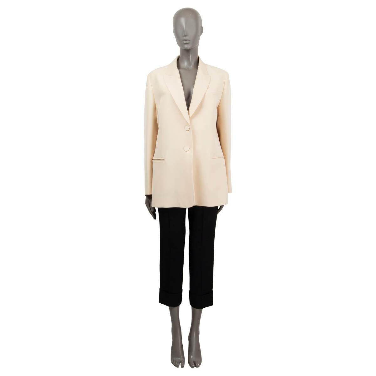 100% authentic Valentino blazer in beige silk (64%) and wool (36%). Features a peak lapel and two welt pockets. Closes with two fabric covered buttons on the front and is lined in silk (100%). Has been worn and is in excellent
