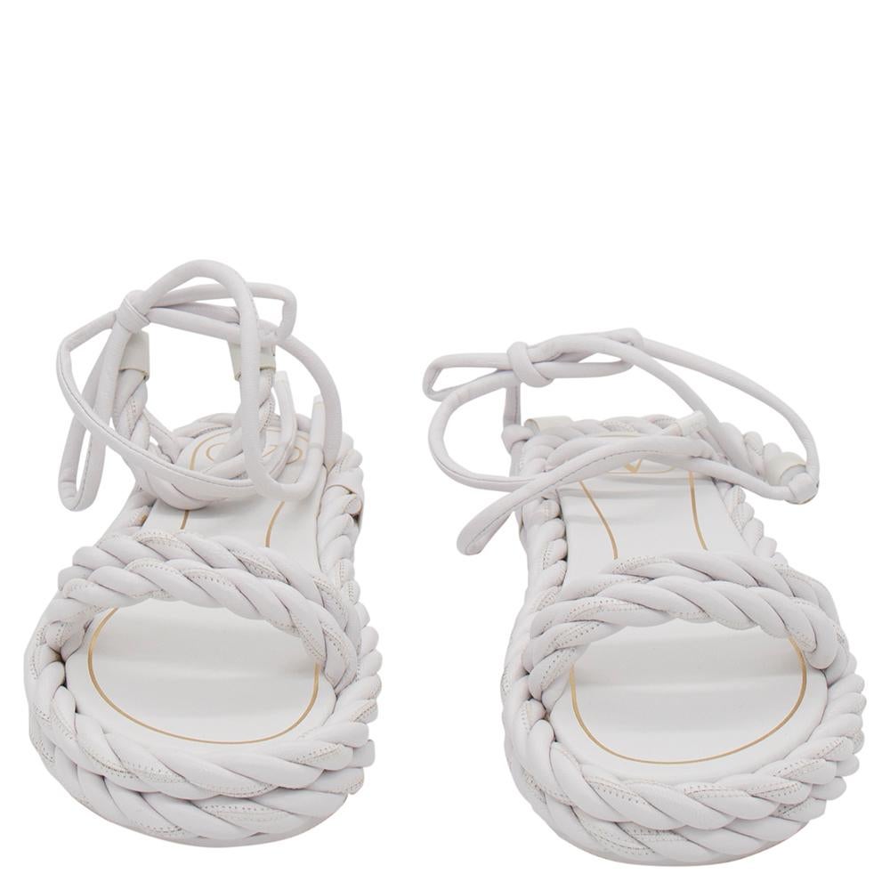 These white Valentino sandals are made from leather in a braided style, have open toes, and ankle wraps. Pair them with a complementing dress to continue the label's elegant mood.

Includes: Original Packaging