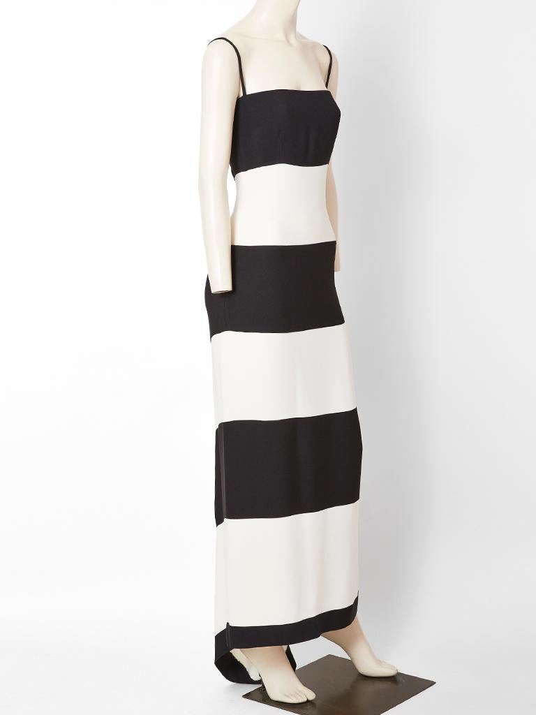 Valentino, three ply crepe, simple, black and white evening dress having wide, horizontal, black and white stripes in the front and a bias placed chevron panel in the back with a small train. Dress has a narrow silhouette held up by thin spaghetti