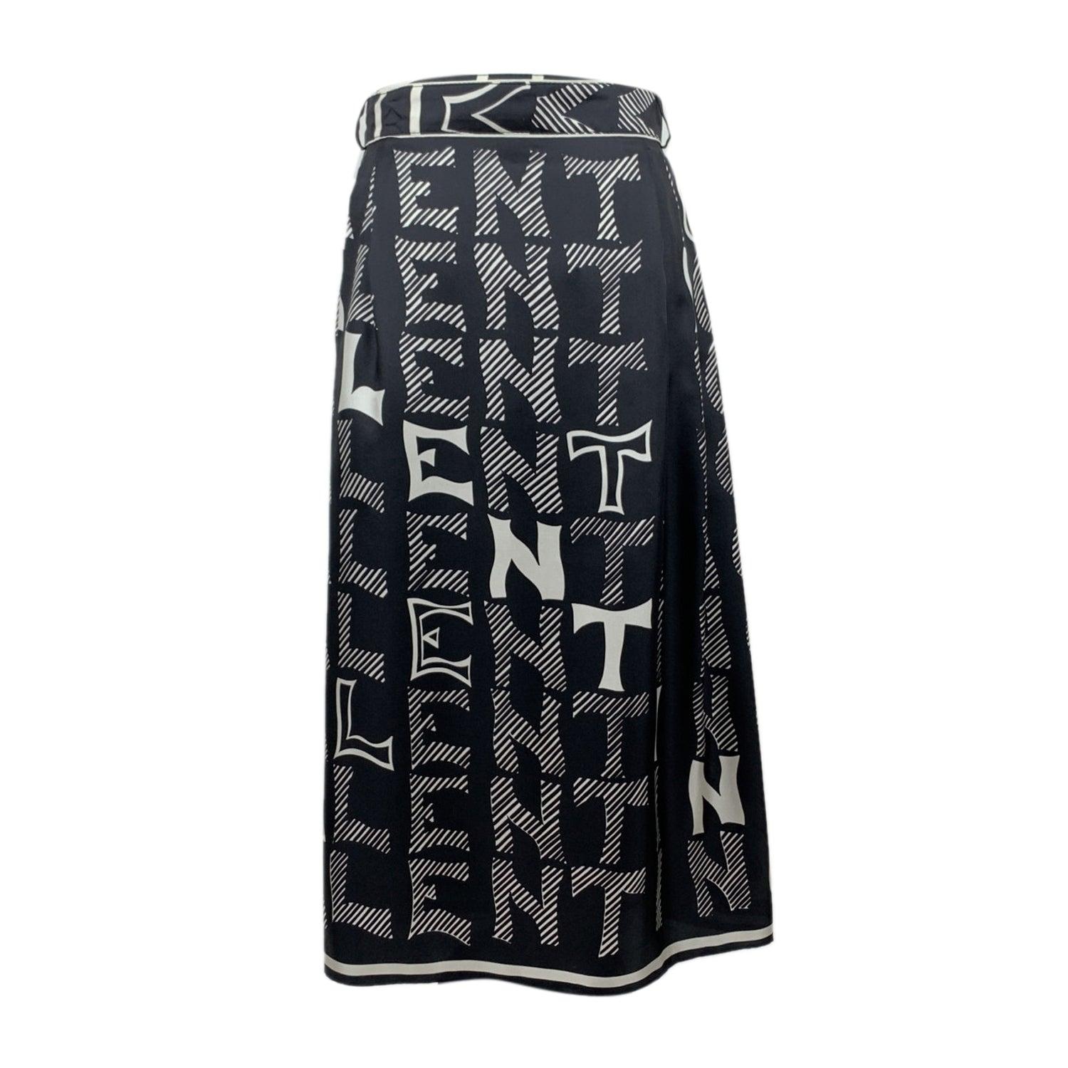 Valentino black and white silk long skirt with contrast Valentino signature pattern. Side button closure. Belted waistline. Front double slits. Composition: 100% Silk Size: 42 IT (The size shown for this item is the size indicated by the designer on