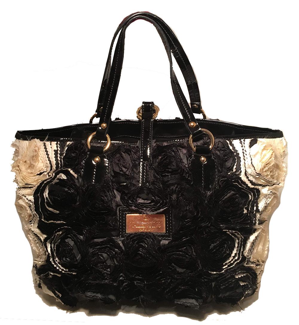 Valentino Black and White Silk Rosier Roses Tote Bag in very good condition. Black and white silk organza rosettes embroidered throughout the exterior. Black patent leather trim and gold hardware. Top strap buckle closure opens to a black silk