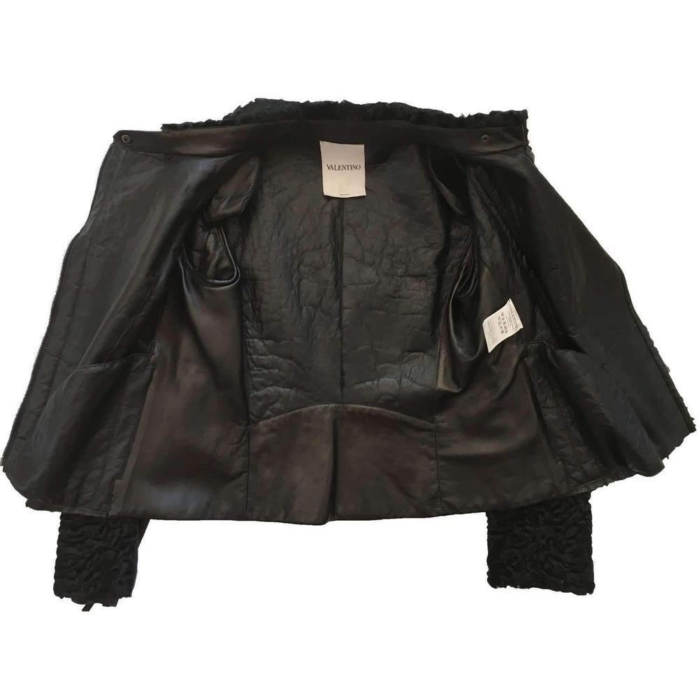 Black Astrakhan lamb fur karakul bomber jacket from Valentino. 
Featuring a front zip fastening, long sleeves, a ribbed elbows and back and zip at cuffs. 
Composition: Afgan Lamb Skin, Goat leather, lamb leather
Specialist Cleaning 
  
Size 42