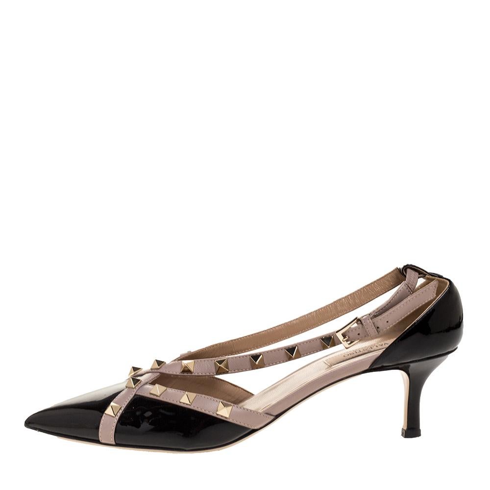 Stand out and strut in style with these Valentino pumps. Crafted from patent and smooth leather, they feature crisscross straps on the vamps accented with Rockstuds, covered pointed toes, buckle fastenings, and kitten heels. Lined with leather, they