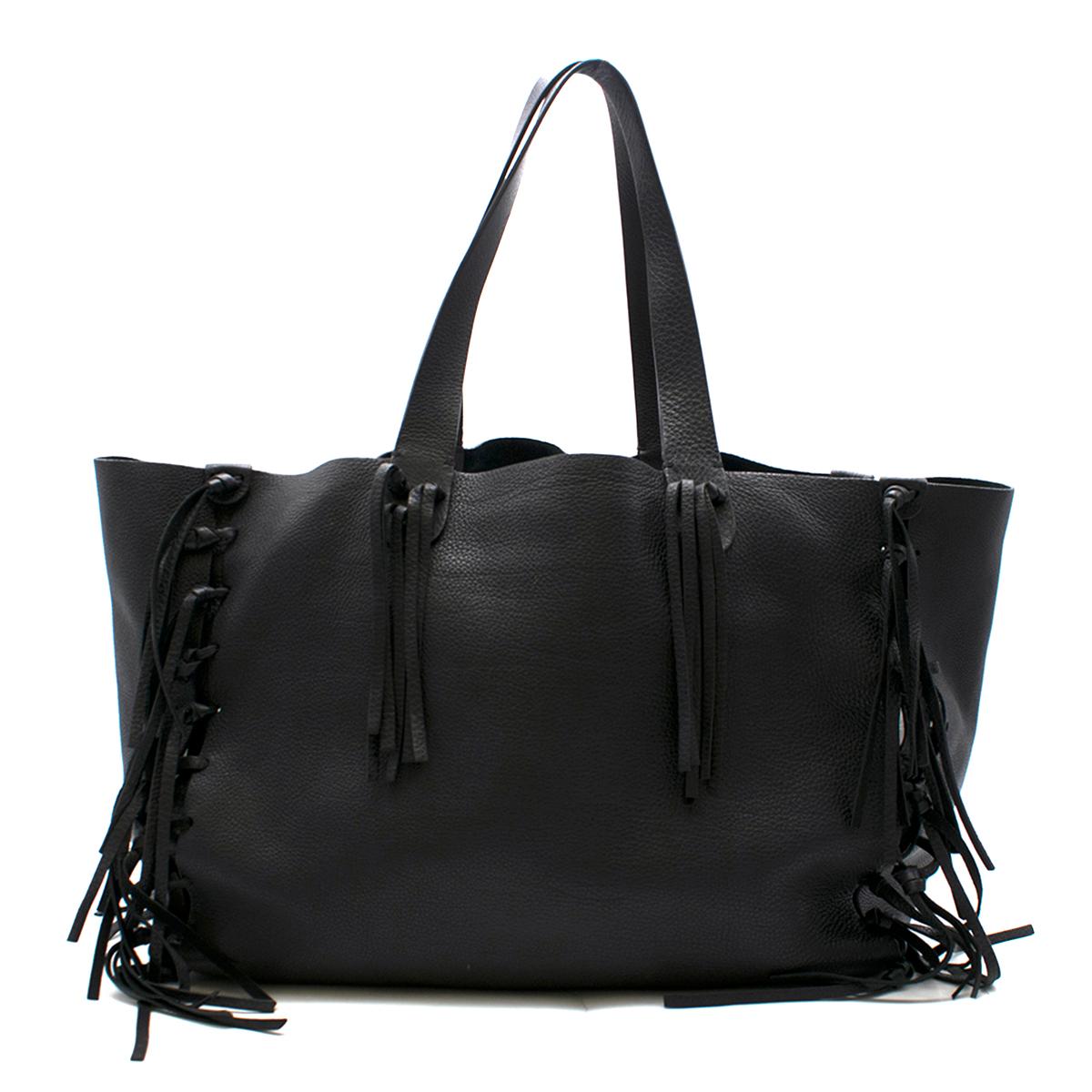 Valentino Black C-Rockee Fringe Leather Tote Bag

- Black leather tote bag
- Mid-weight
- Flat shoulder straps with tassel fringe bases
- Fringe detail trims sides of spacious body
- Suede lining
- Internal two zip pockets and two open pockets
-