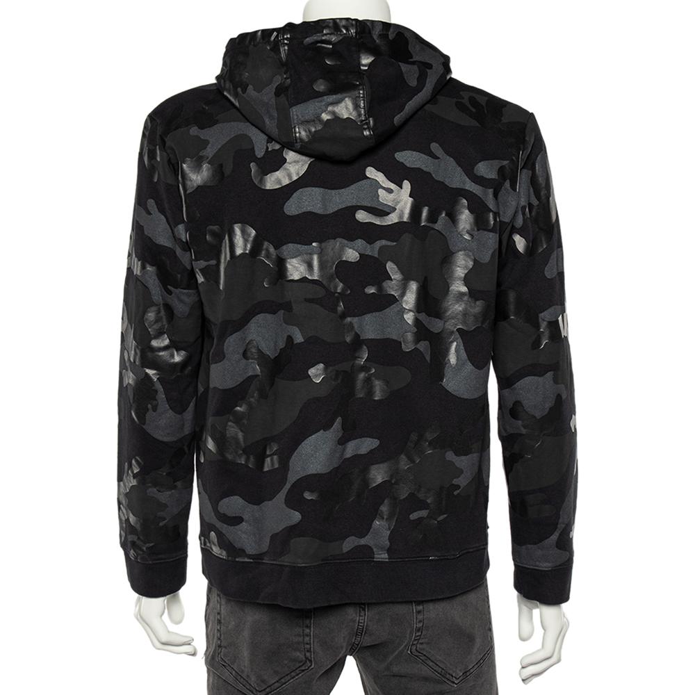 Sport a trendy, voguish style with this sweatshirt from Valentino. By wearing this classy jacket, your attire is bound to appear classy. It is tailored using black camouflage printed cotton with a zip-up feature on the front. It features two