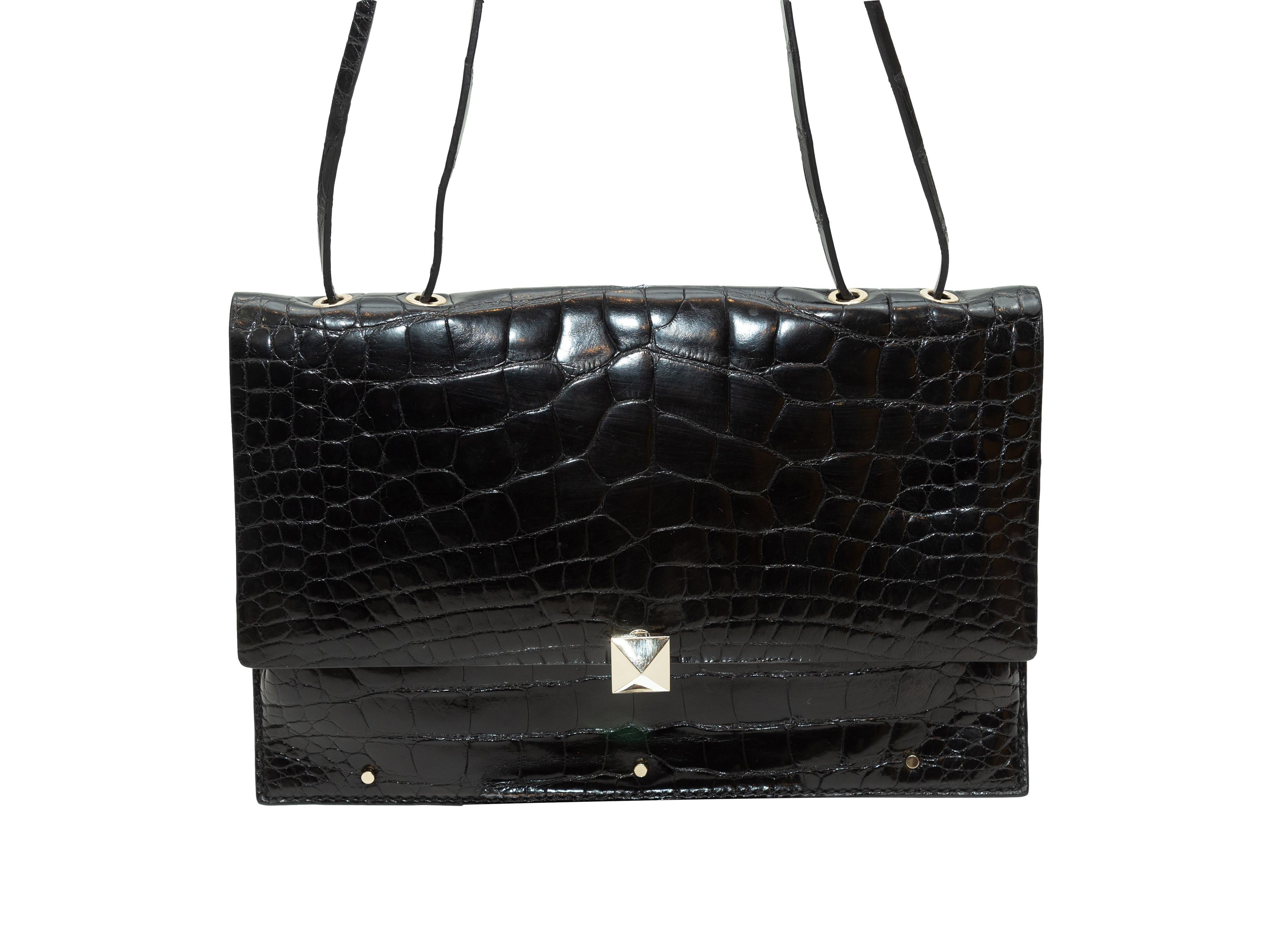 Product details: Black crocodile shoulder bag by Valentino. Silver-tone hardware. Adjustable strap. Interior card slot pockets. Rockstud closure at front flap. 11.5