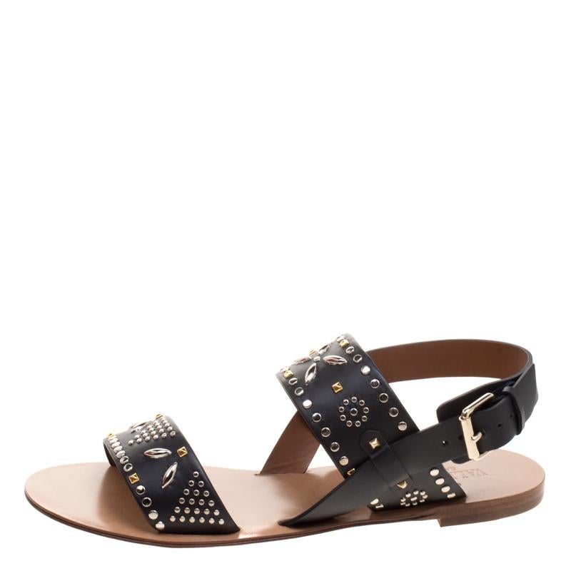 How trendy are these flat sandals from the house of Valentino! They've been crafted from leather and designed with straps that carry gorgeous embellishments. You can wear them with your casual outfits or with dresses.

Includes: Original Box,