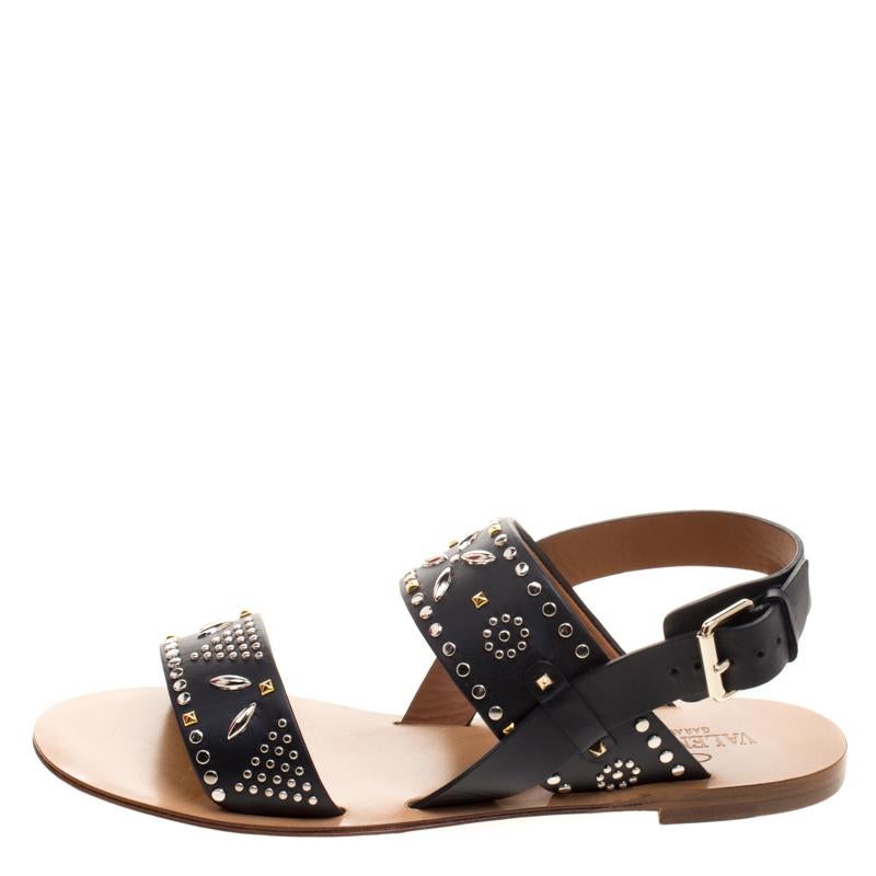 How trendy are these flat sandals from the house of Valentino! They've been crafted from leather and designed with straps that carry stud embellishments. You can wear them with your casual outfits or with dresses.

Includes: Original Box


